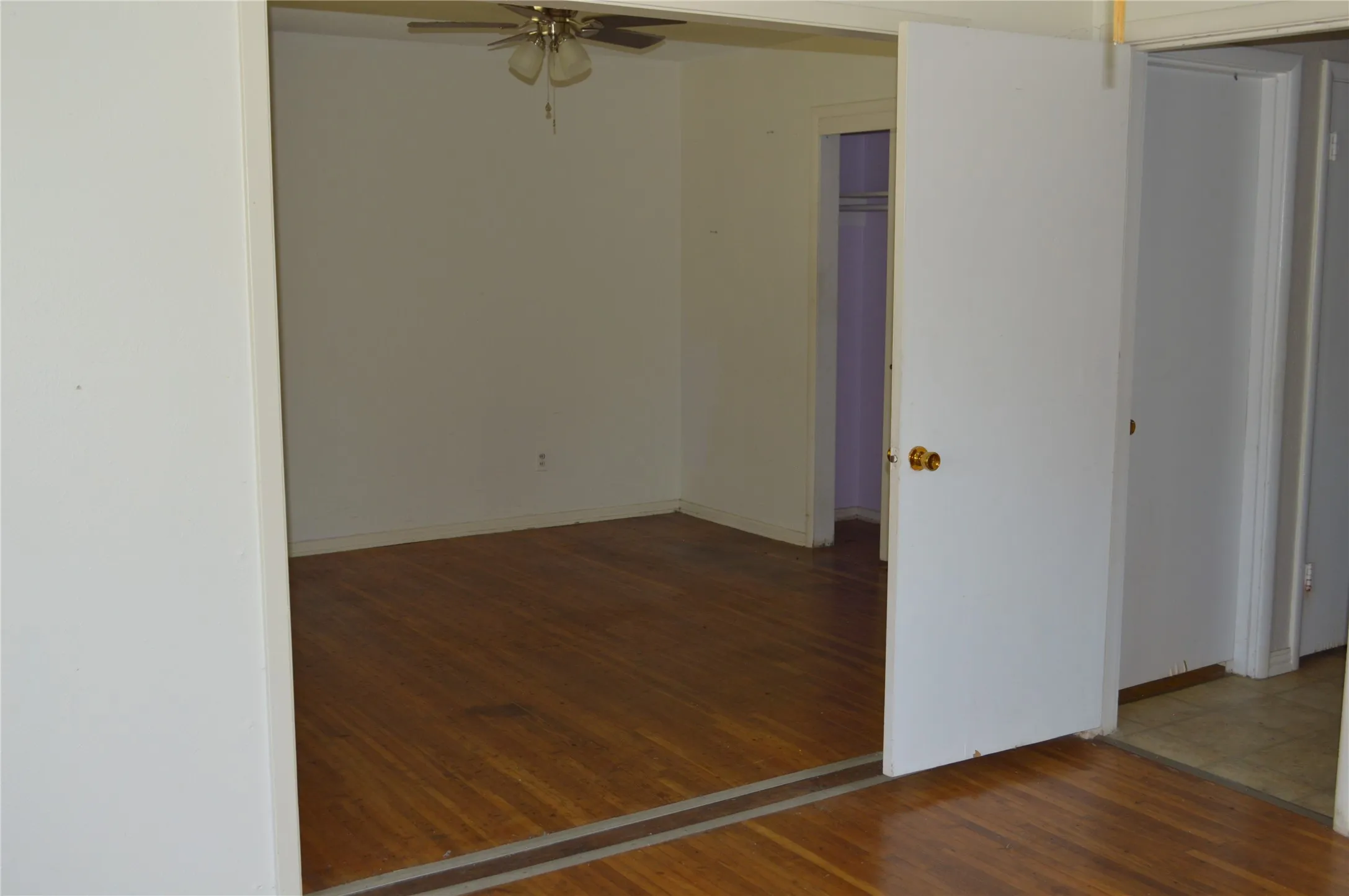 Primary opens into the third bedroom