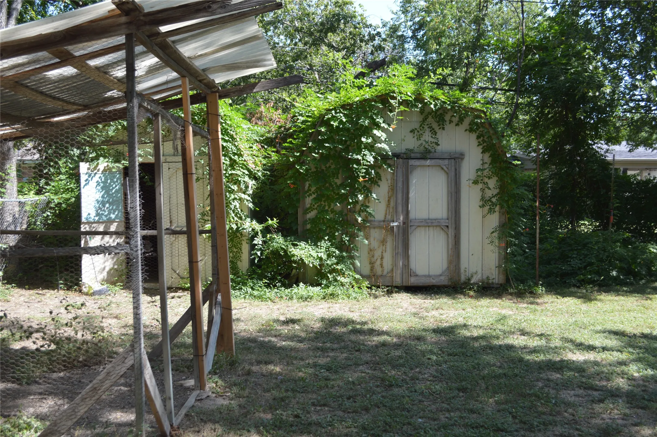 Two storage buildings and a chicken coop