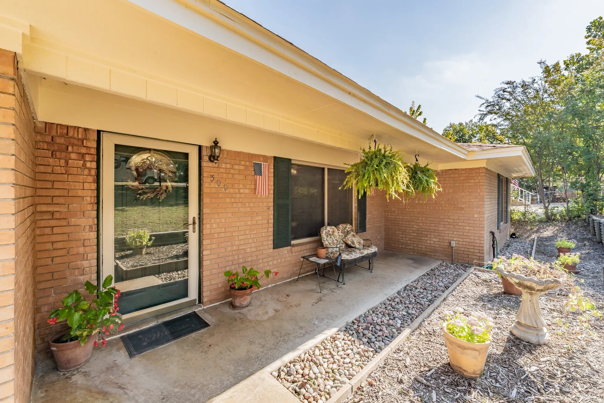 Property entrance with brick siding, covered porch