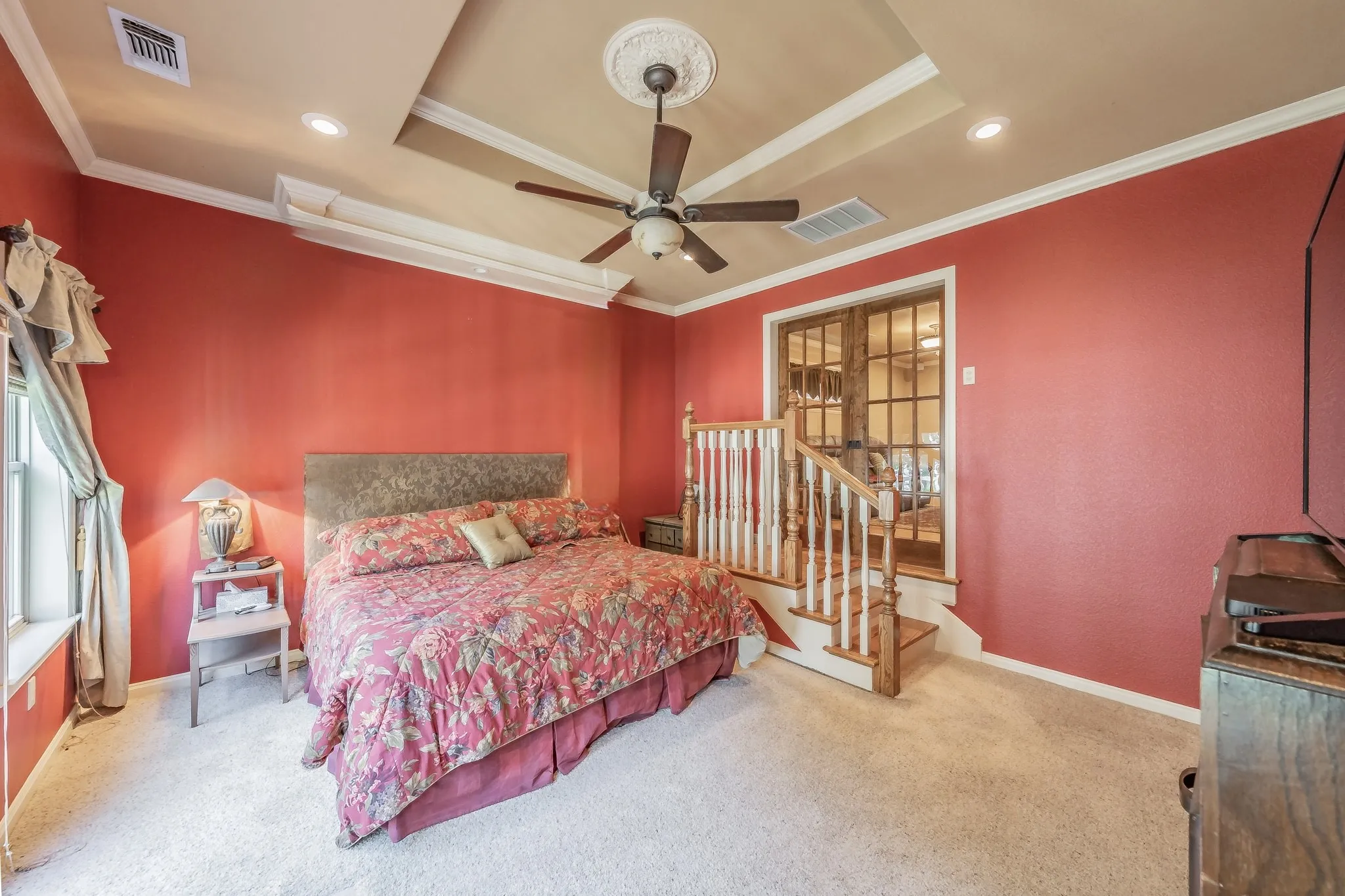 Bedroom featuring recessed lighting, carpet floors, crown molding, a tray ceiling, and a ceiling fan