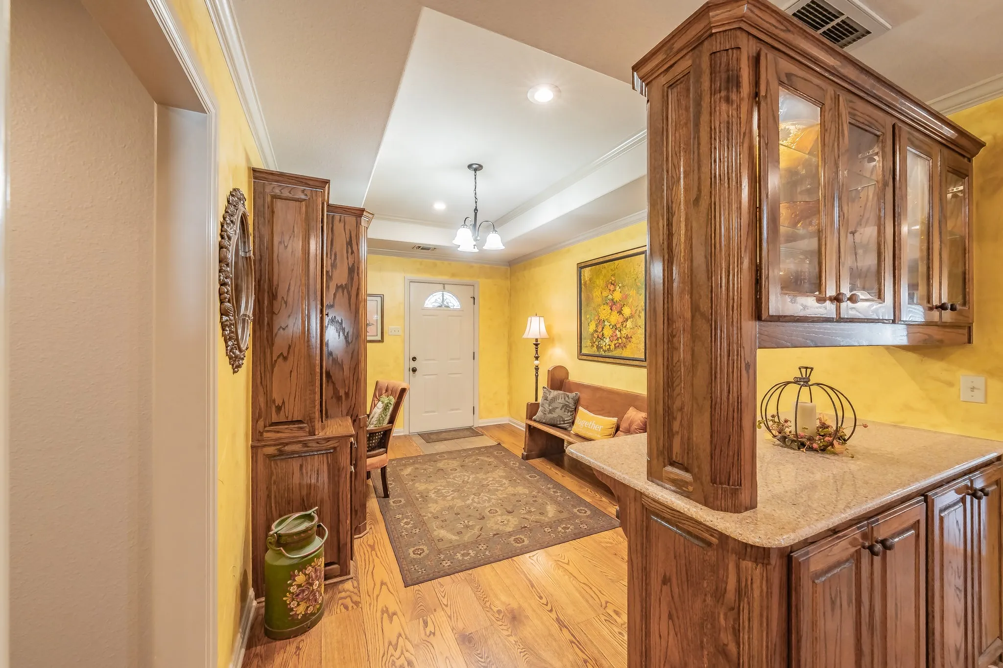 Foyer entrance featuring crown molding, light wood-style floors, a chandelier, and recessed lighting