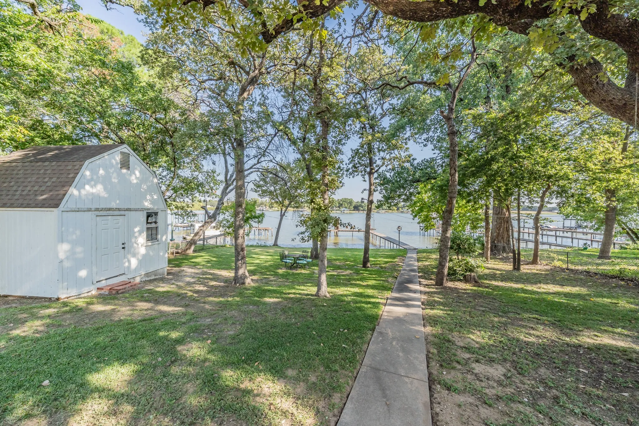 View of yard featuring a water view and a shed