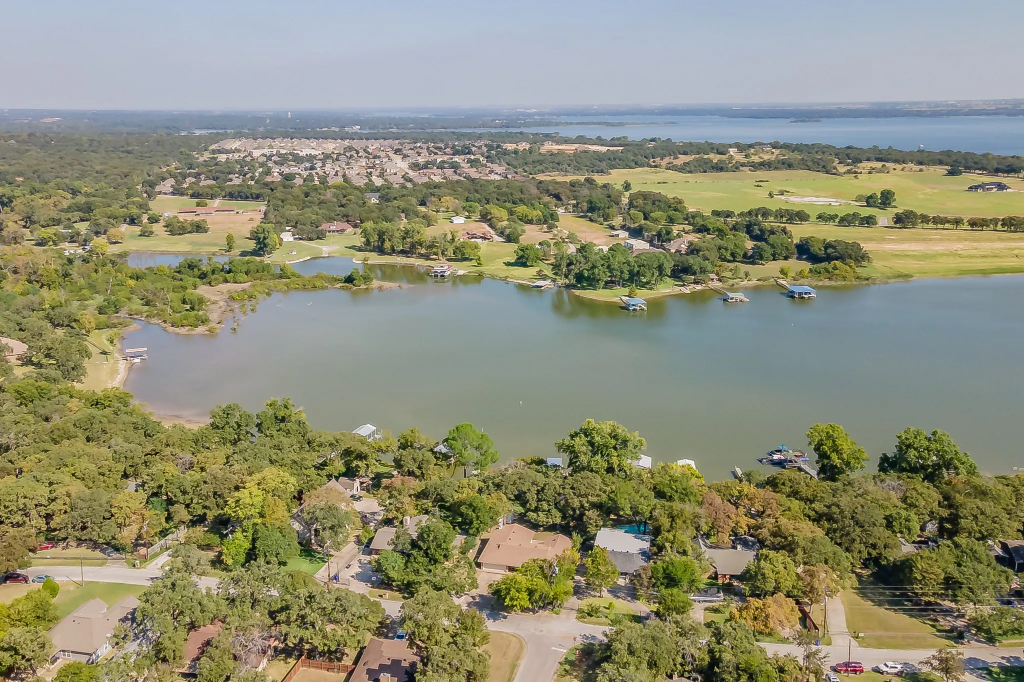 Aerial overview of property's location featuring a large body of water and nearby suburban area
