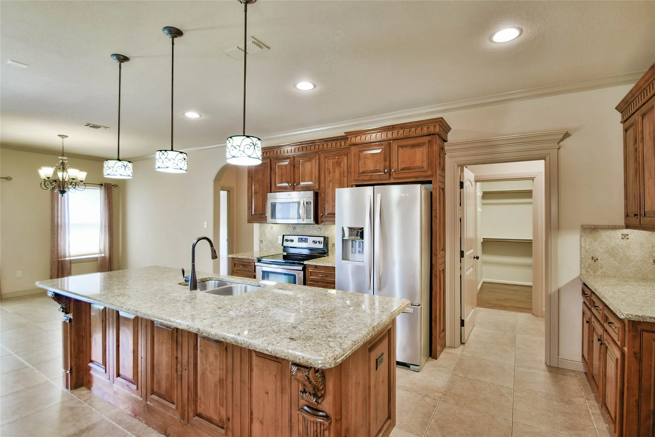 Kitchen features custom cabinets, granite, SS appliances