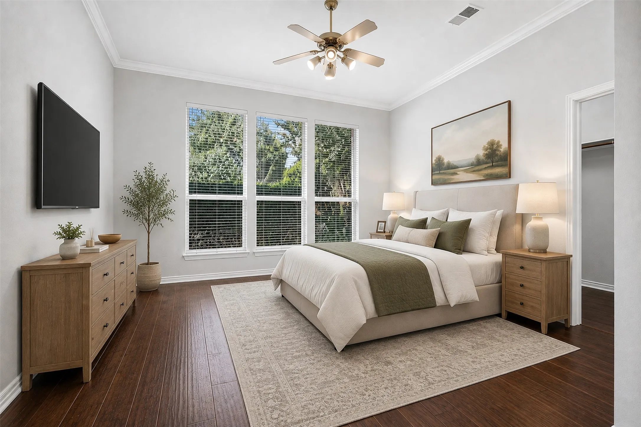 Hardwood-finish flooring, crown molding, three large windows with blinds, and a ceiling fan with integrated lighting