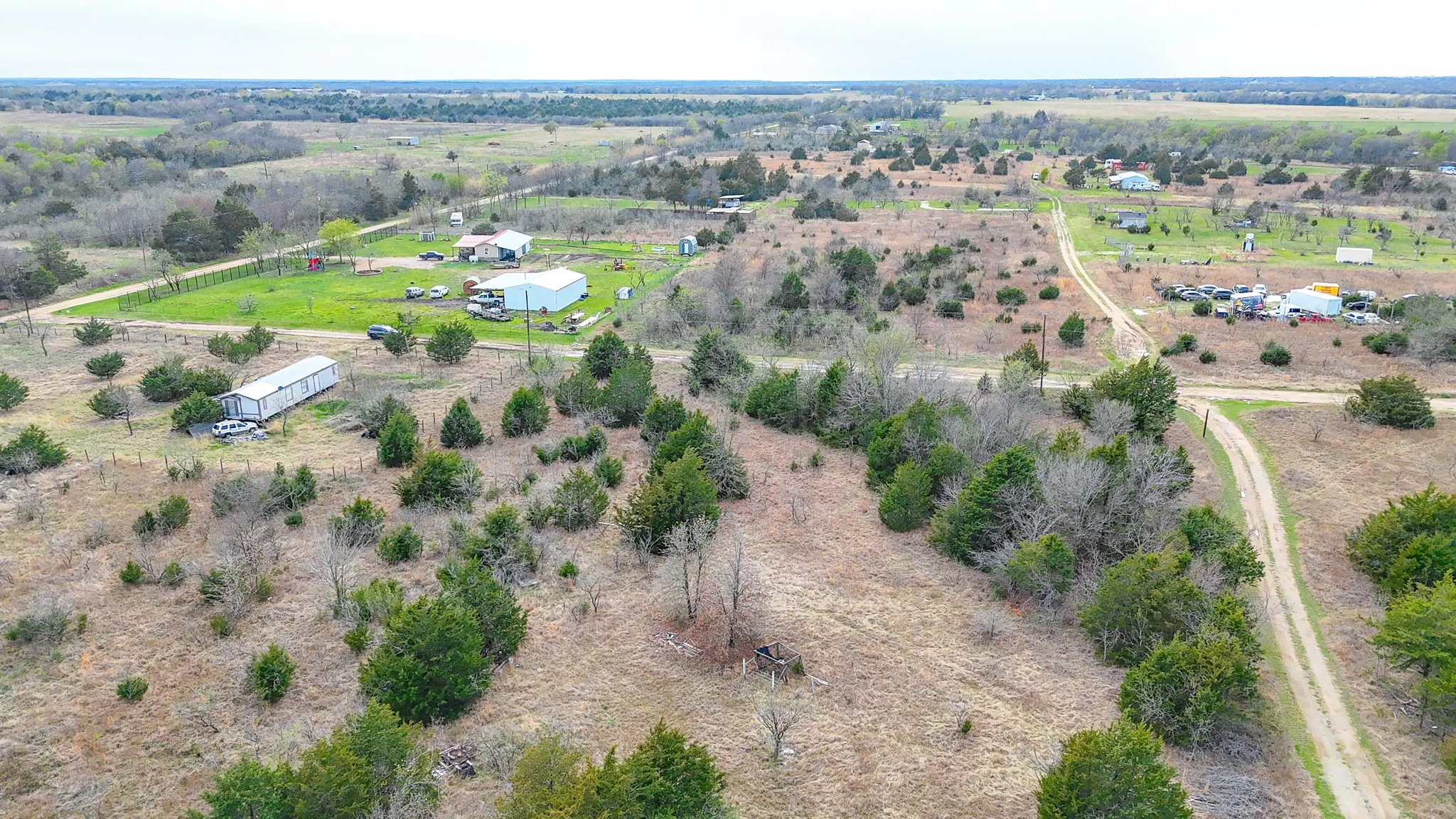Expansive undeveloped land featuring natural terrain and established trees