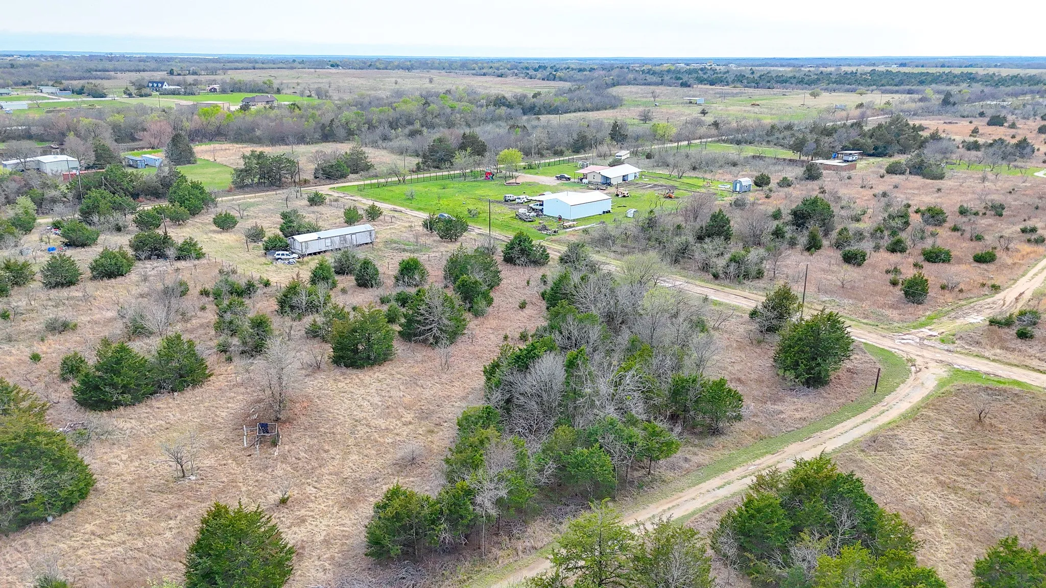 Expansive parcel featuring a mix of mature trees and open fields