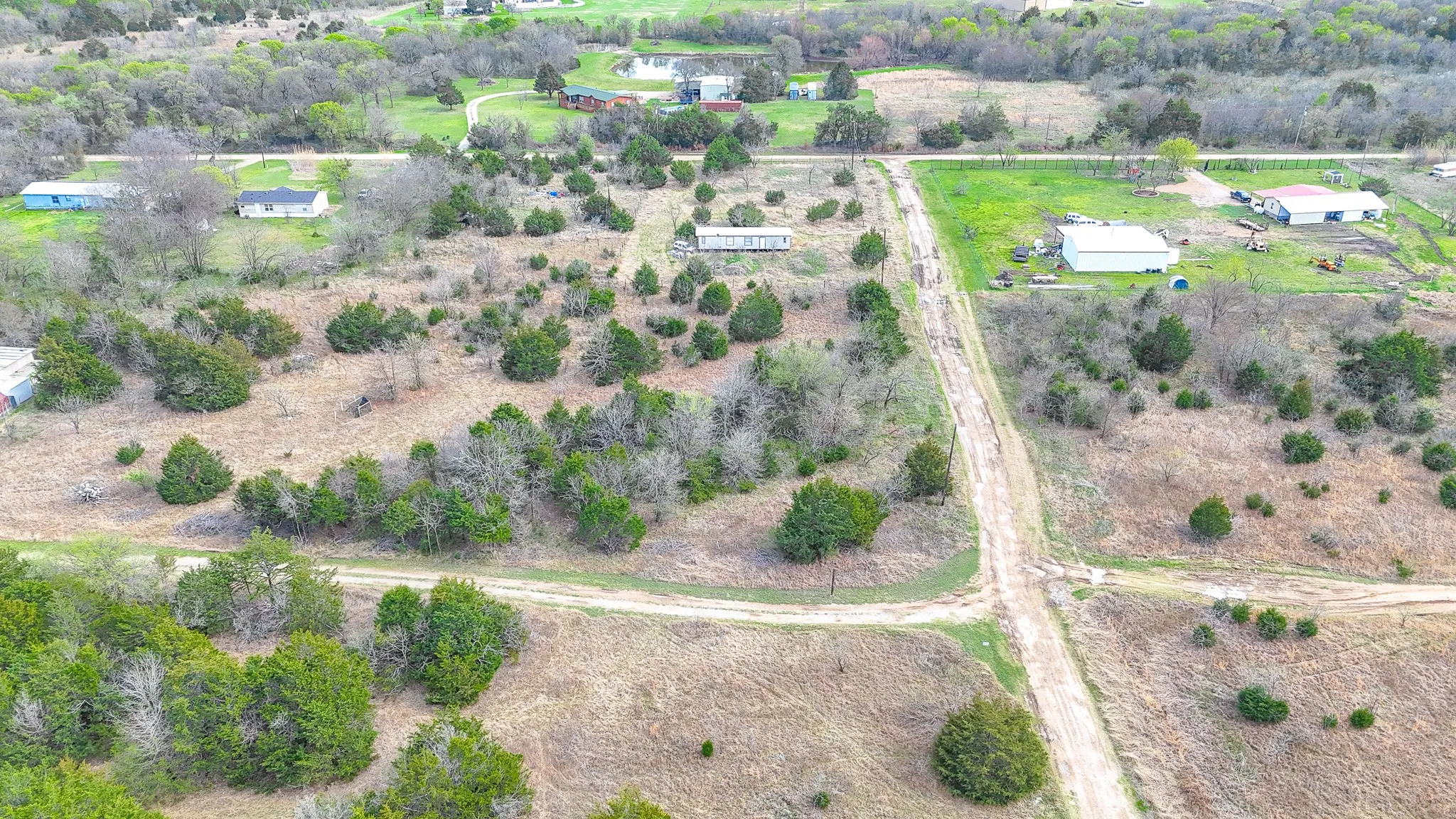 Expansive undeveloped land featuring natural terrain and sparse tree coverage