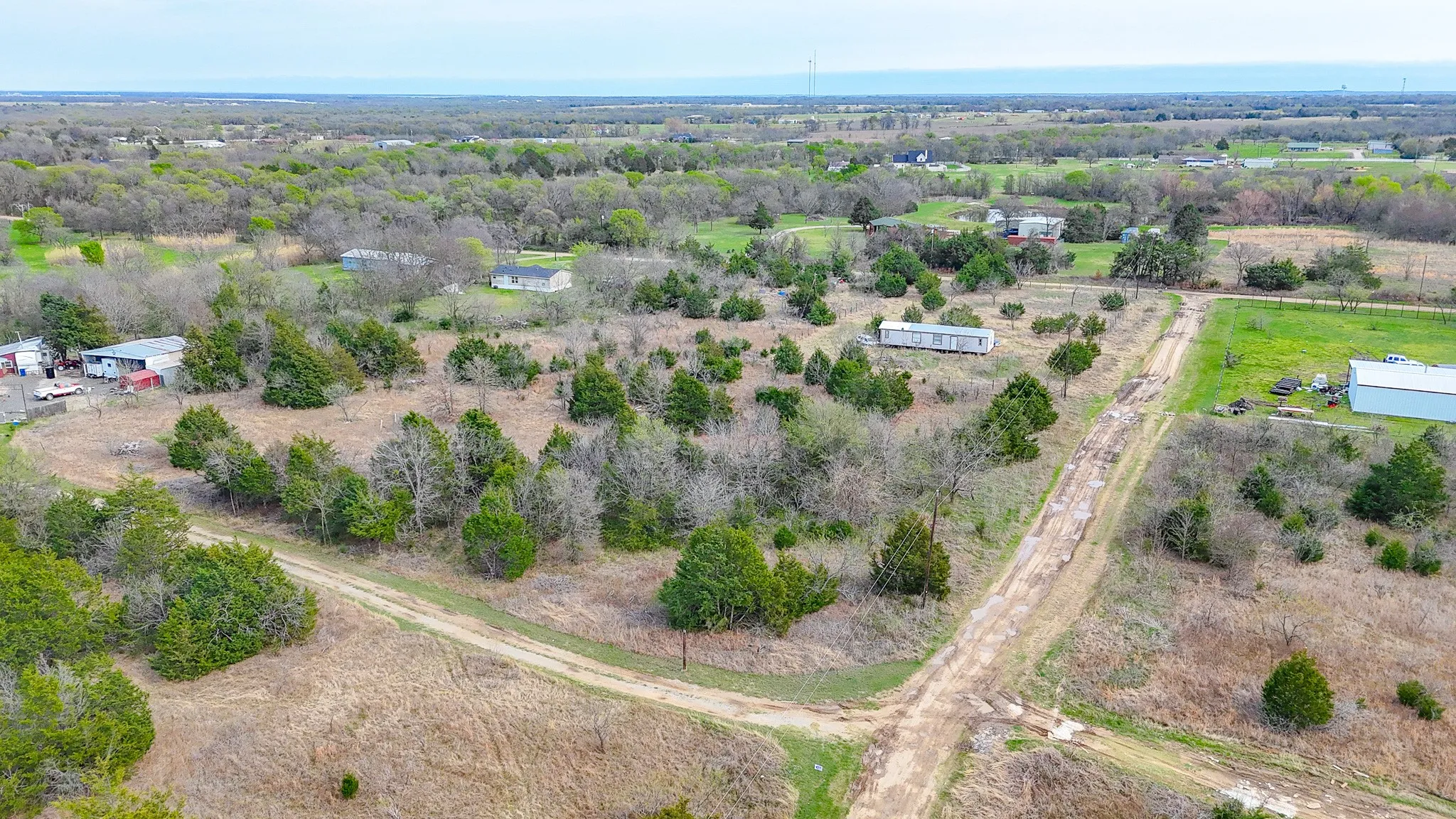 Expansive acreage featuring established trees and multiple clearings