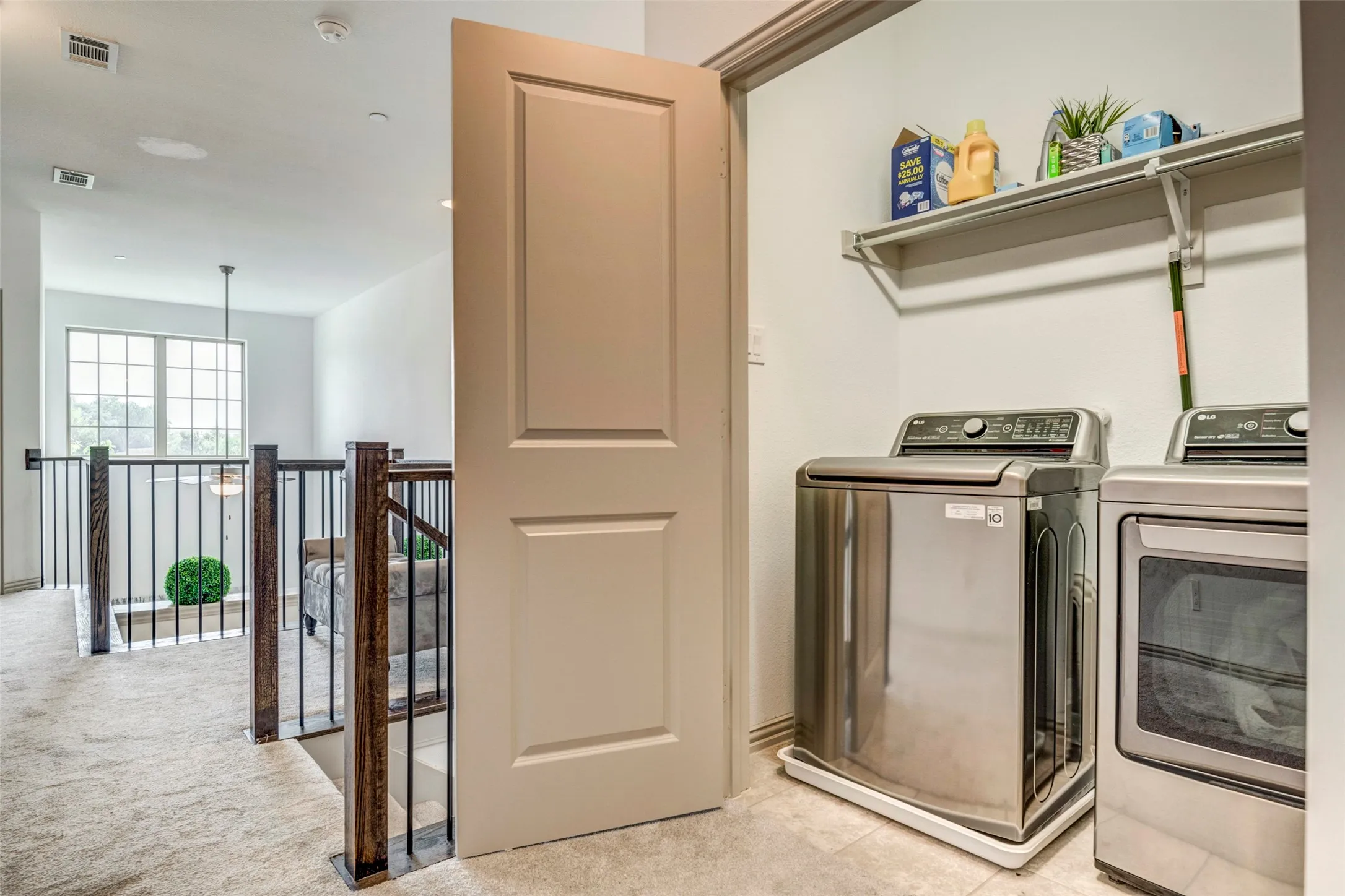 Dedicated laundry area featuring a built-in shelf and hanging rod