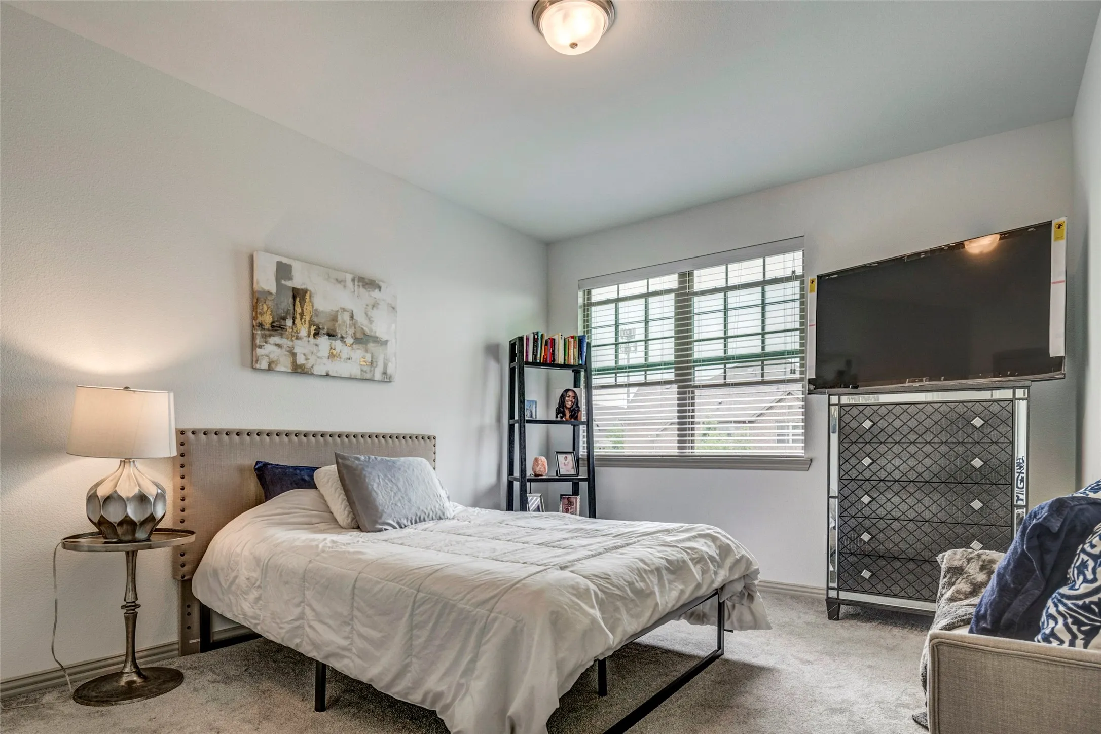 Bedroom featuring carpet flooring, a window with blinds, and white walls
