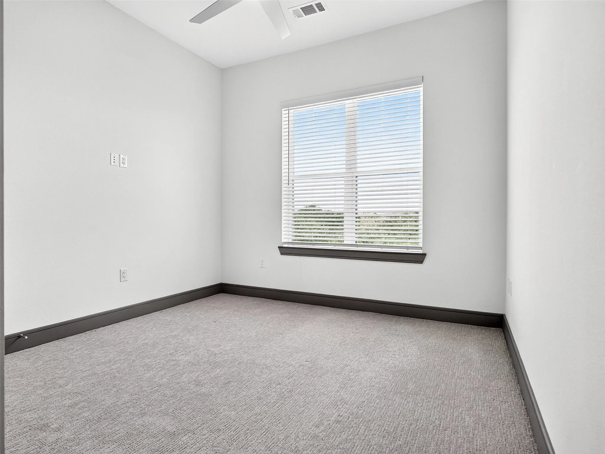 Recessed lighting, ceiling fan, carpet flooring, window with blinds, and dark-toned trim