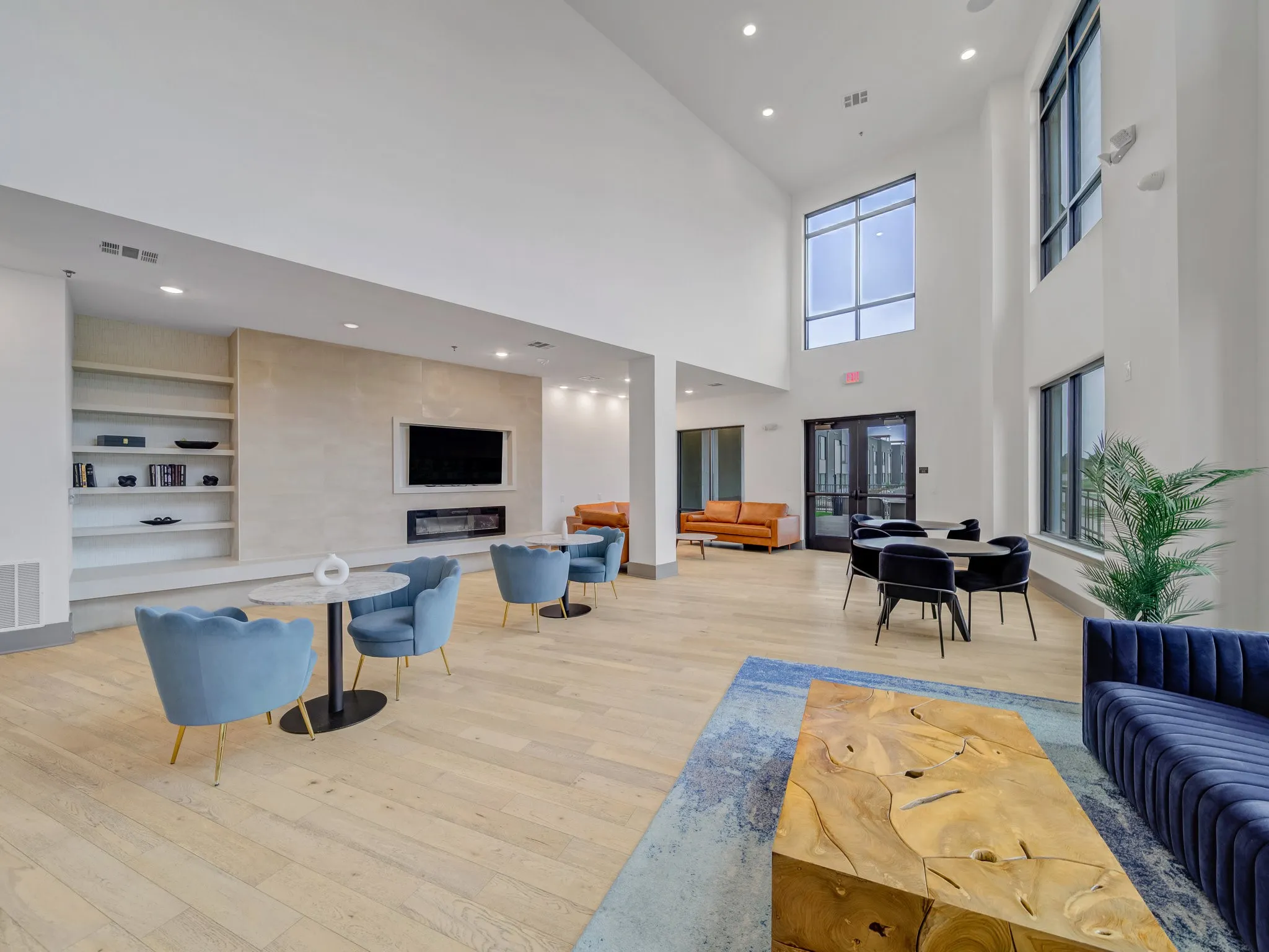 High ceilings, wood-finish flooring, built-in shelving, fireplace, and large windows