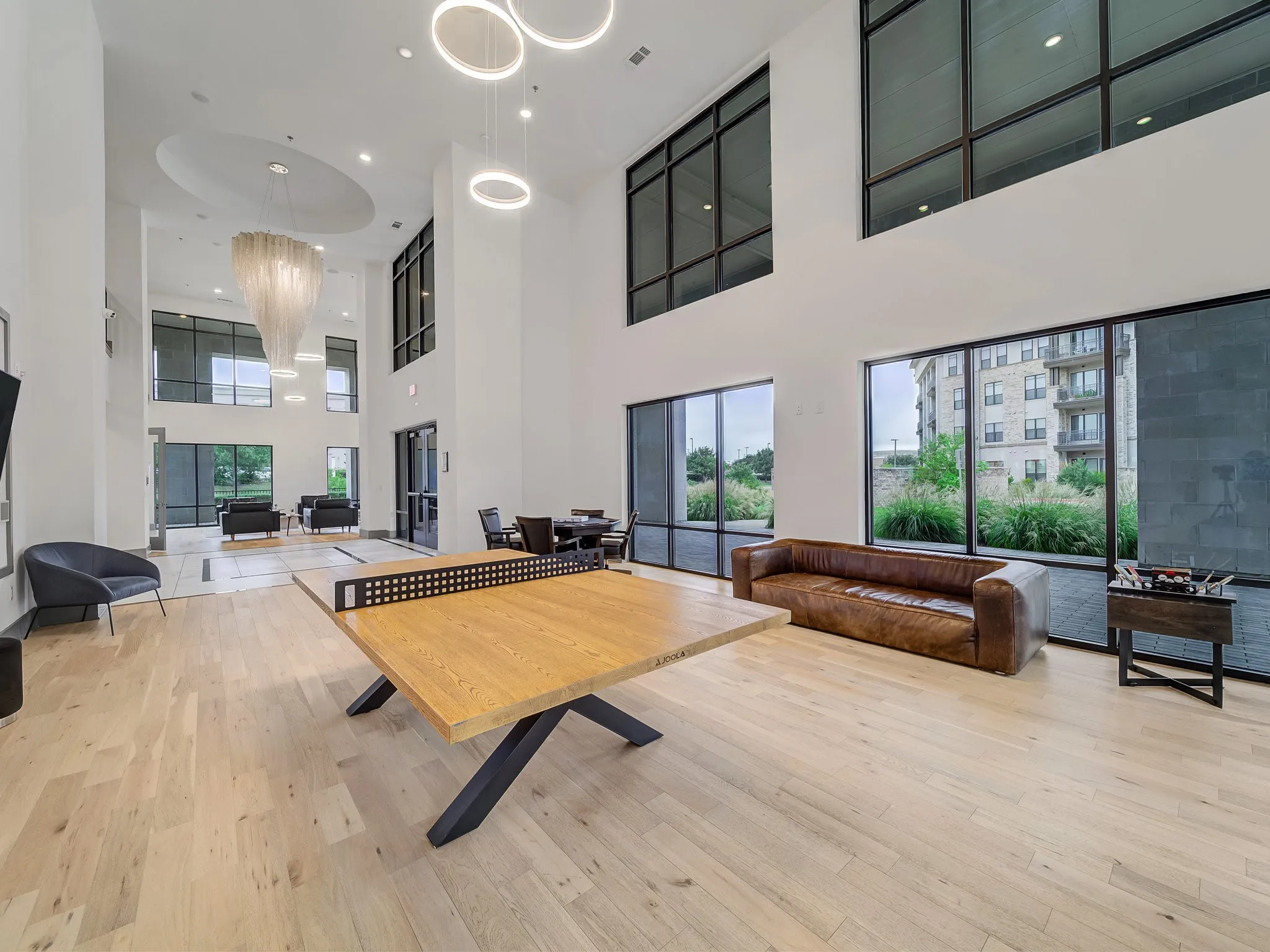 Soaring ceilings with extensive window detailing and light wood-finish flooring