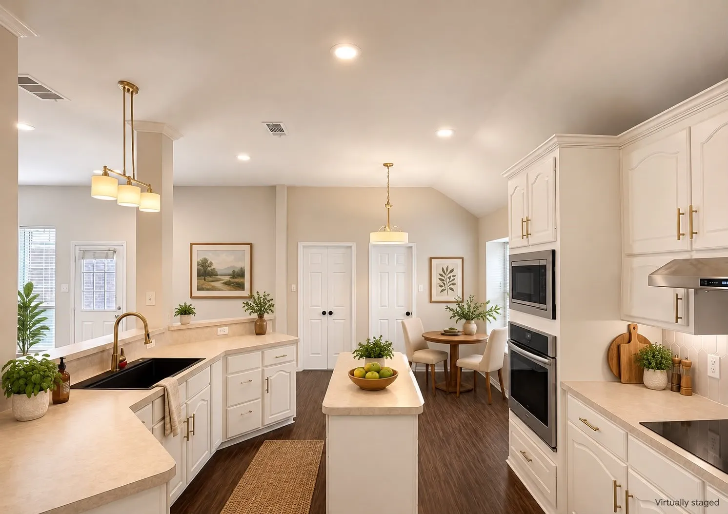 White cabinetry with gold-tone hardware, wood-finish flooring, built-in stainless steel appliances, recessed lighting, and a kitchen island