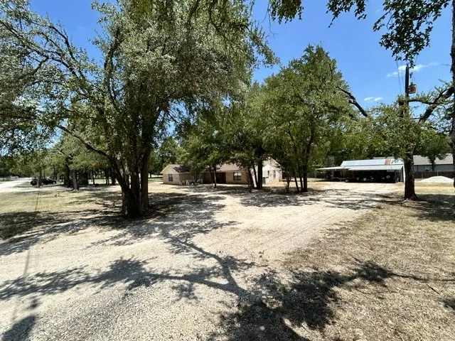 Second driveway entrance of the circle driveway, leading to the front of the home and the shop with additional covered parking.