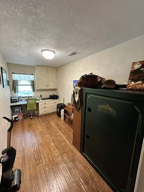 This study can be the craft room you have always wanted.  Look at those built in cabinets.