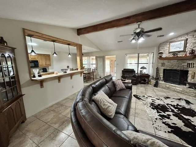 Another view of the living room open to the kitchen and dining areas.