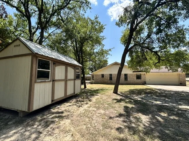 Storage building on garage side of the house.