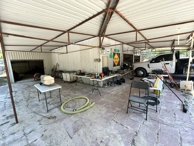 View of the "Porch" area of the workshop.  Pretty cool.  I have not seen this before. Also you can see part of the carport area where the truck is parked.  Pretty handy to have extra covered parking in addition to the two car garage.