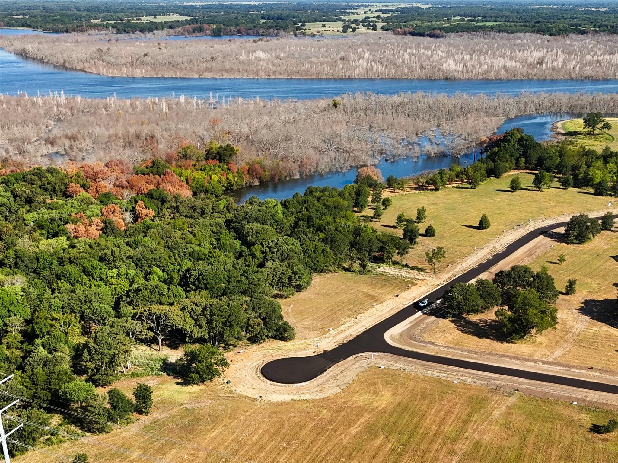 Birds eye view of property featuring a water view and a rural view