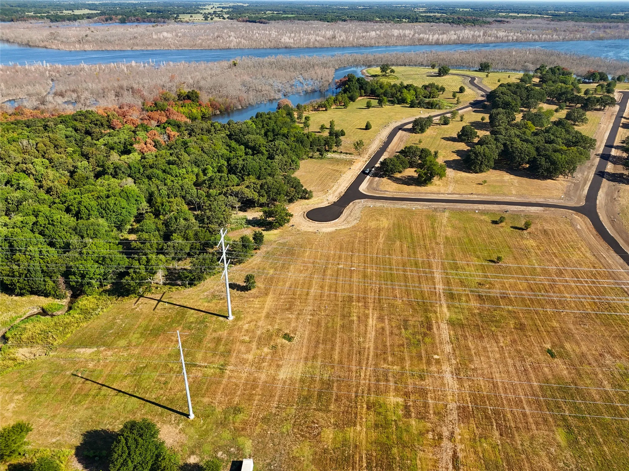 Birds eye view of property with a water view and a rural view