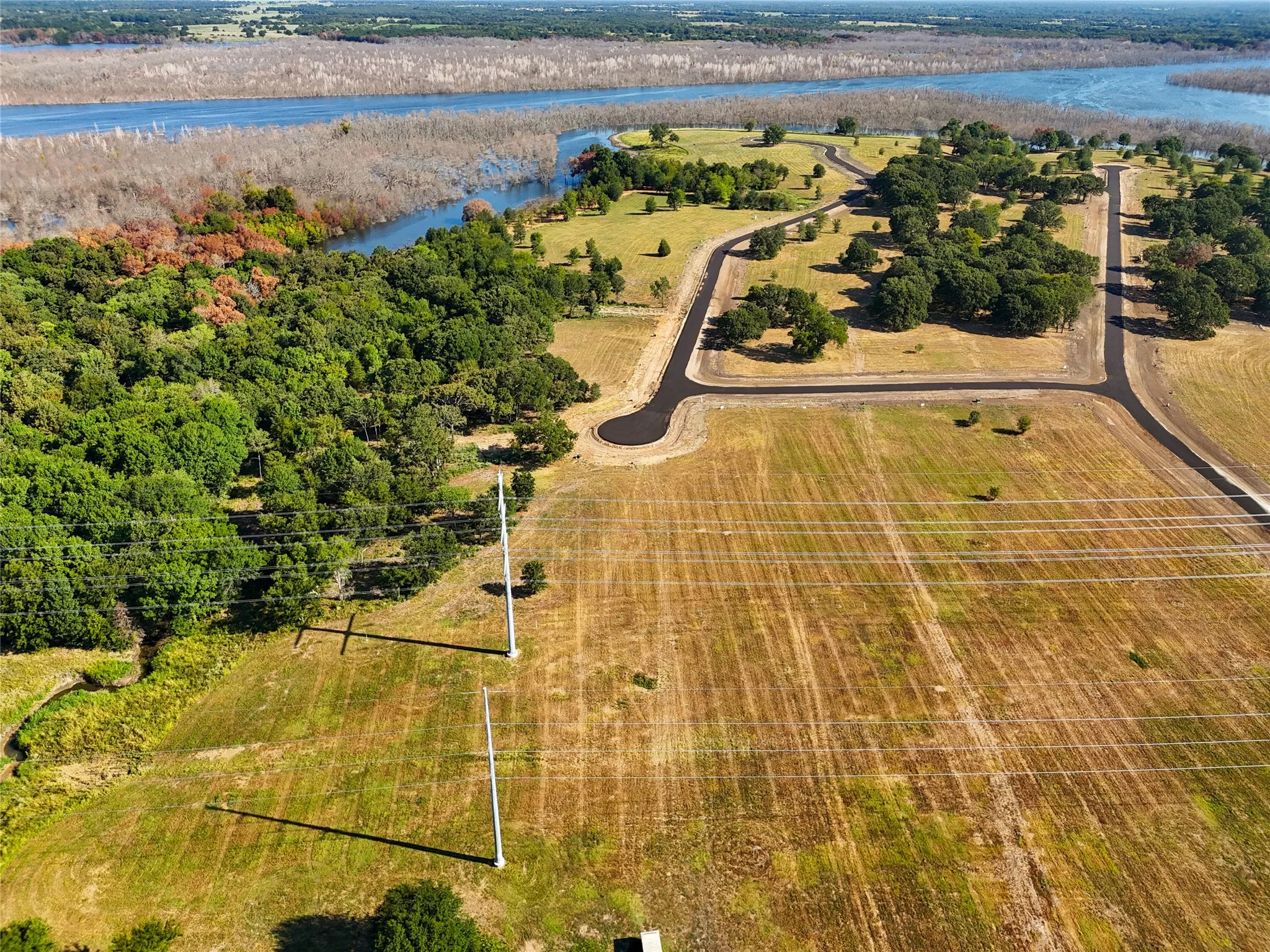 Birds eye view of property with a water view and a rural view