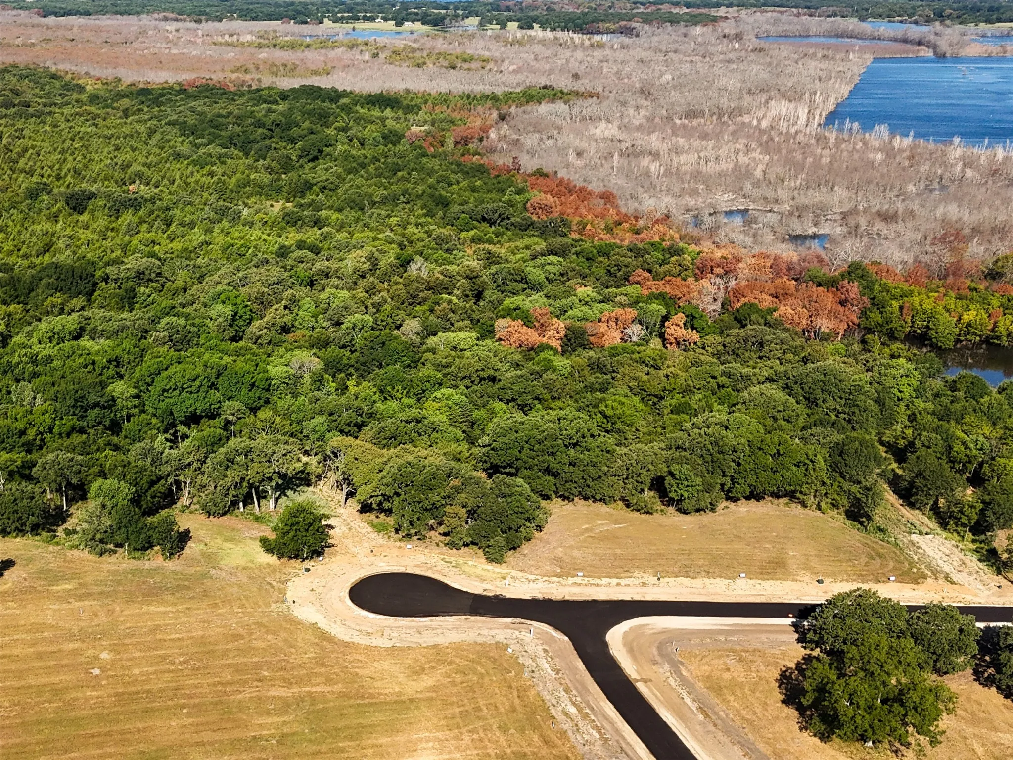 Birds eye view of property with a water view and a rural view