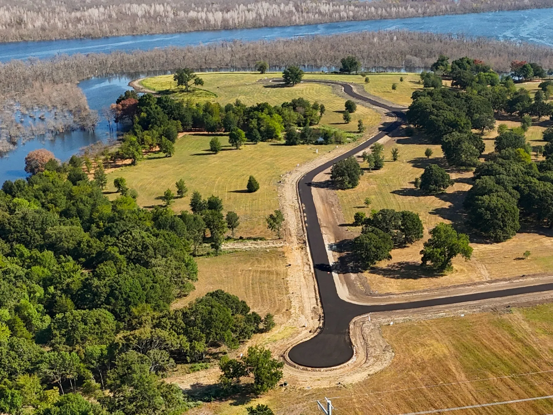 Drone / aerial view with a water view and a rural view