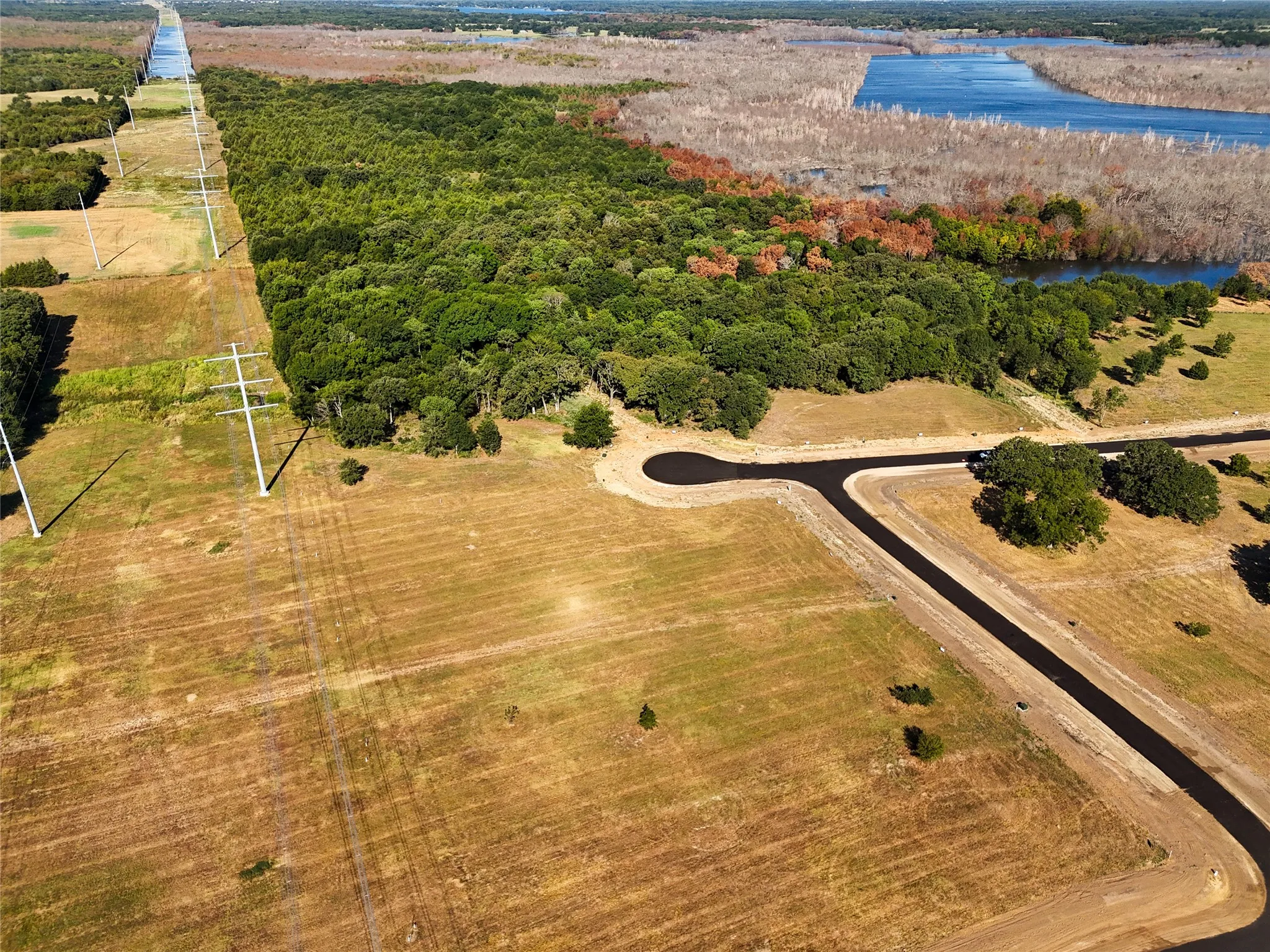 Aerial view featuring a water view and a rural view
