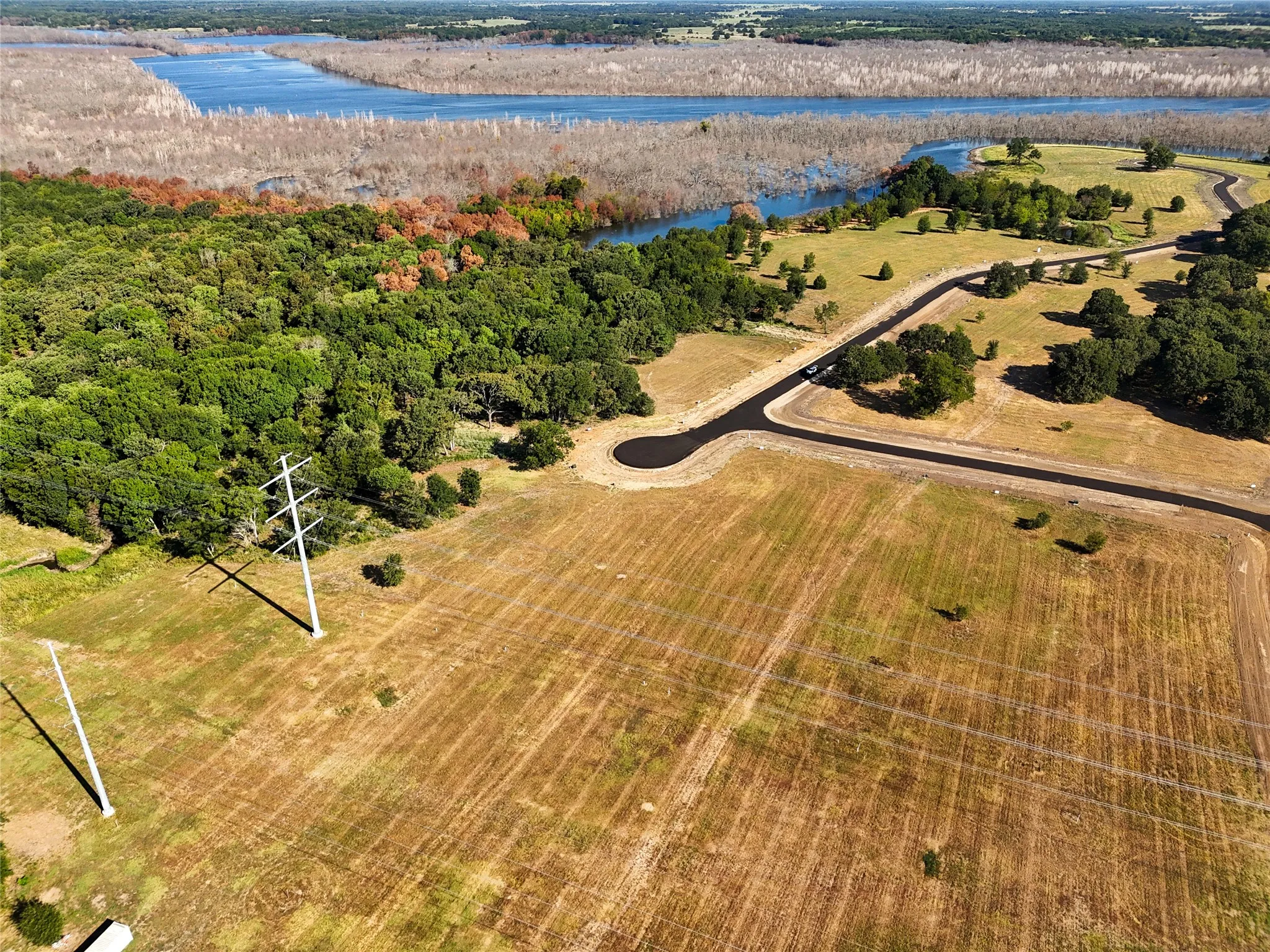 Aerial view featuring a water view and a rural view