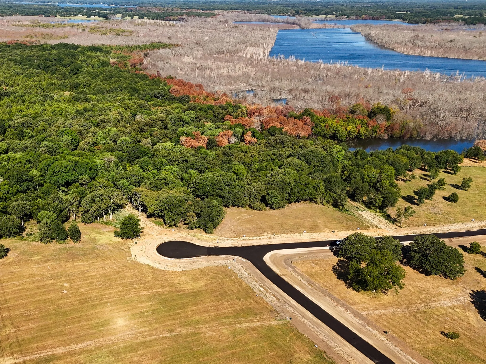 Birds eye view of property with a water view and a rural view