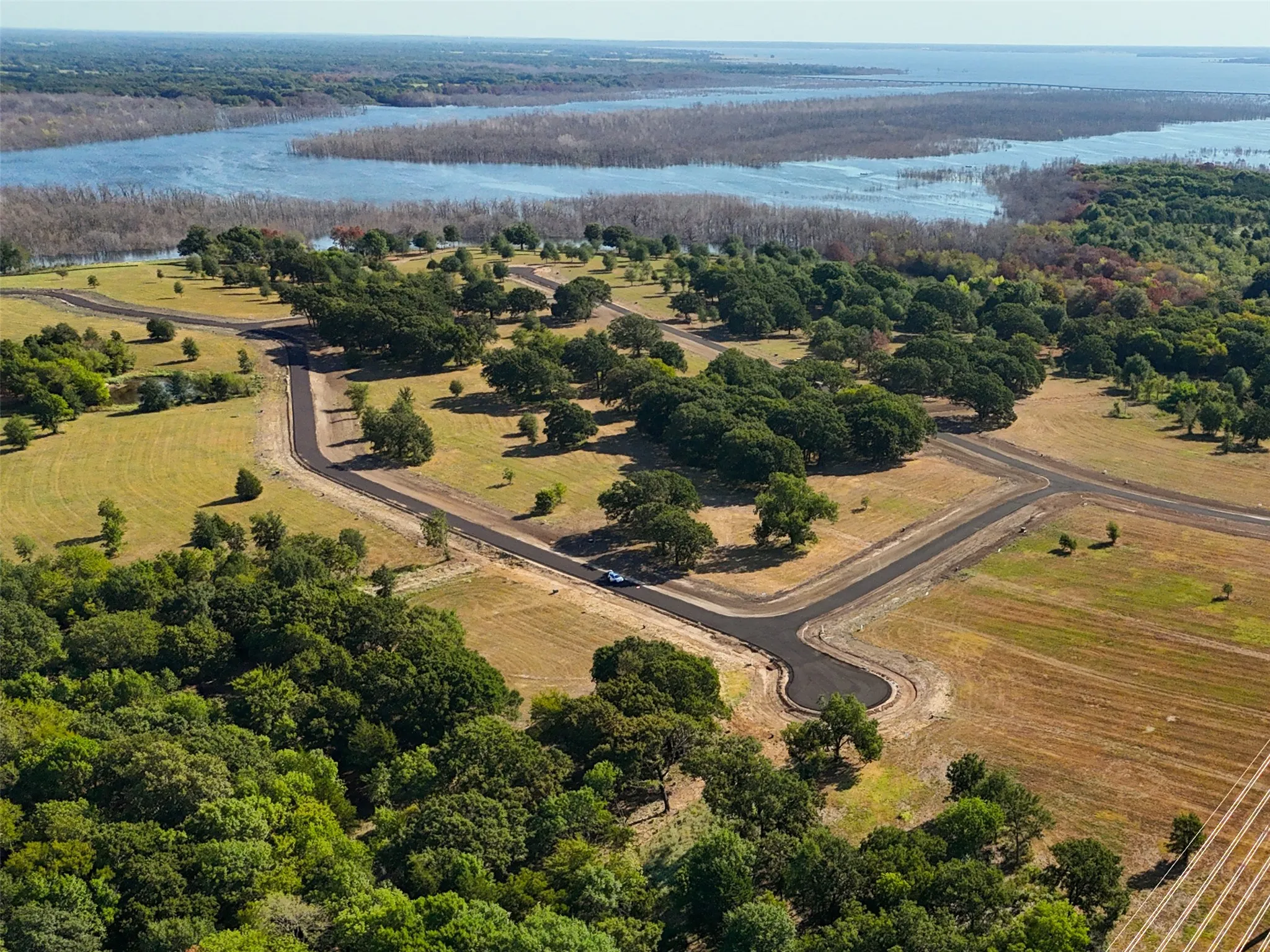 Birds eye view of property featuring a water view and a rural view