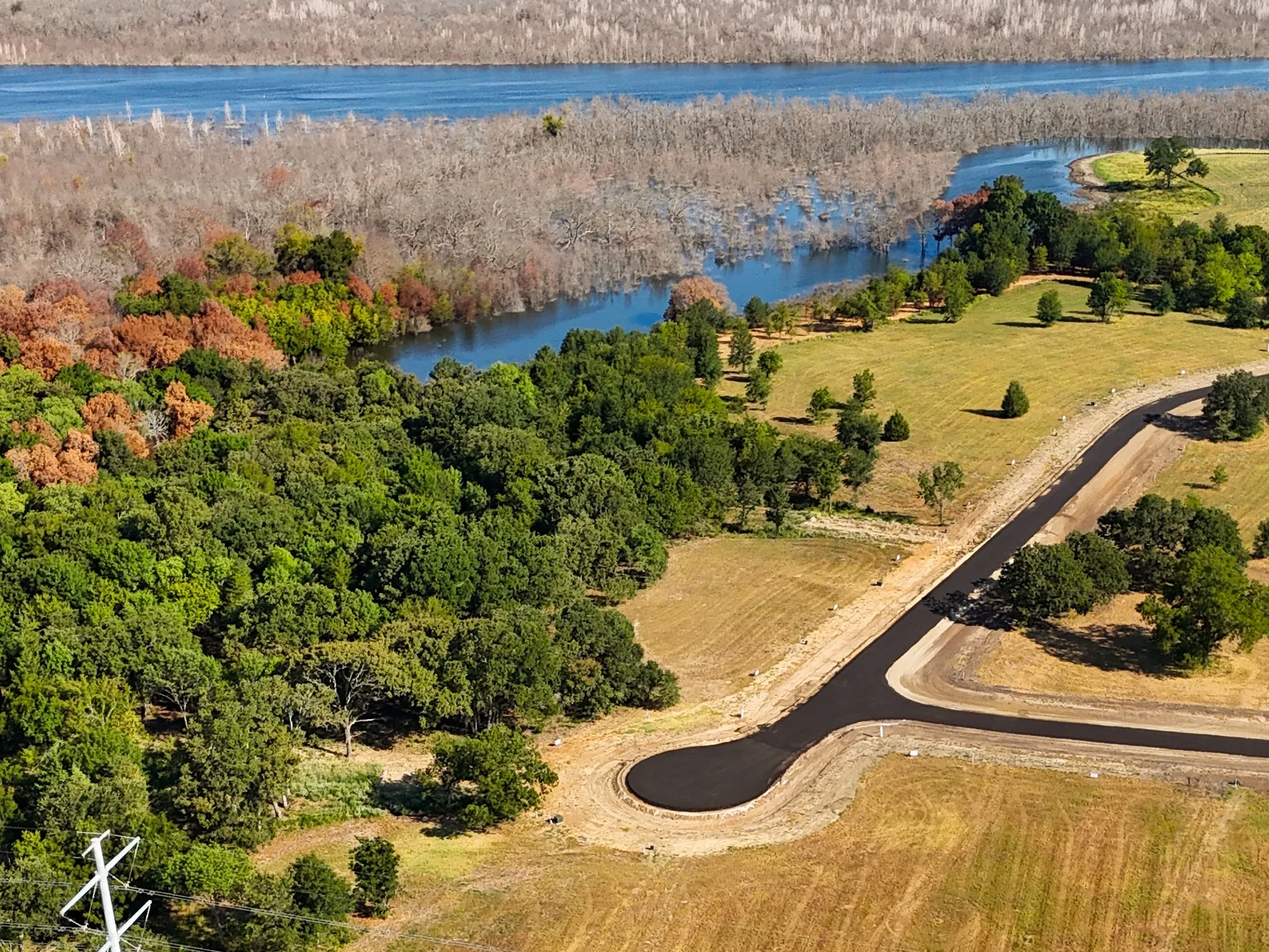 Birds eye view of property with a water view