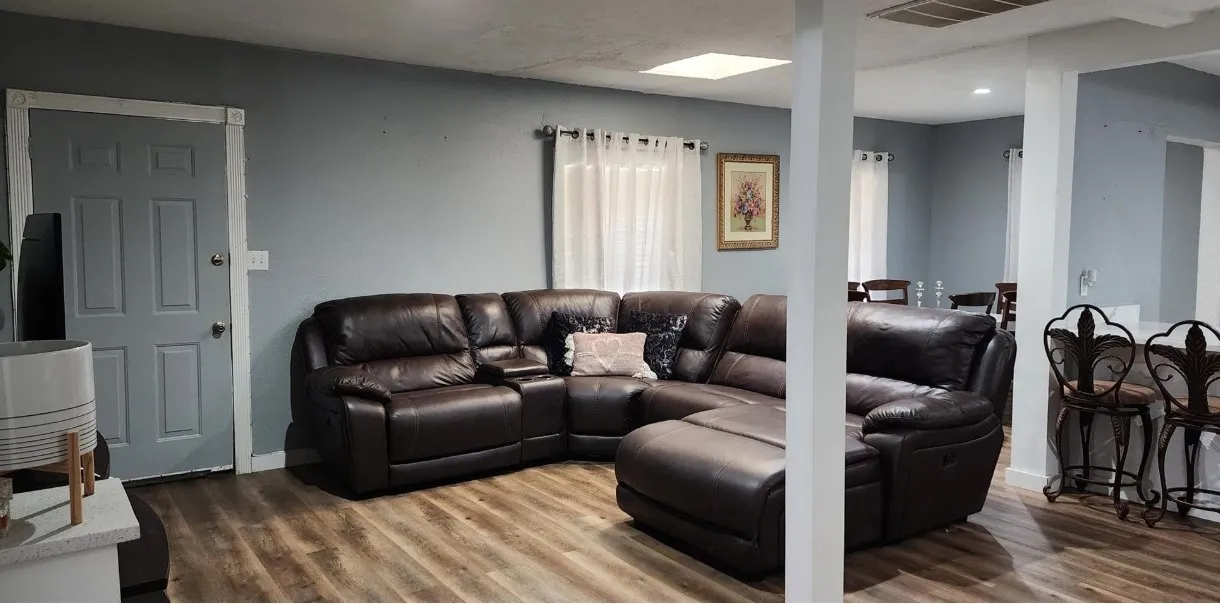 Wood-finish flooring throughout, light blue walls, and white trim
