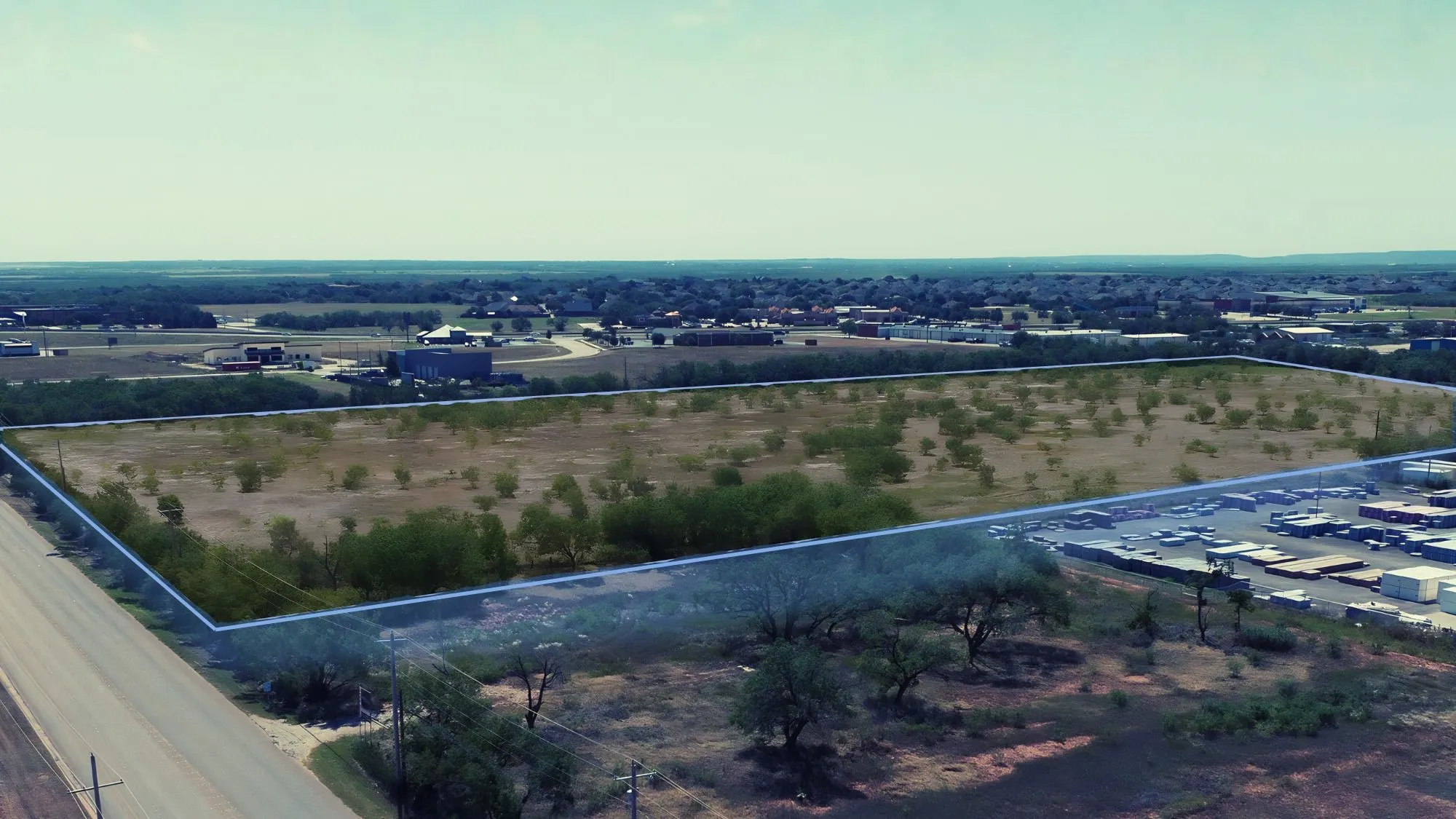 Expansive vacant land parcel featuring clear boundaries and a surrounding developed area