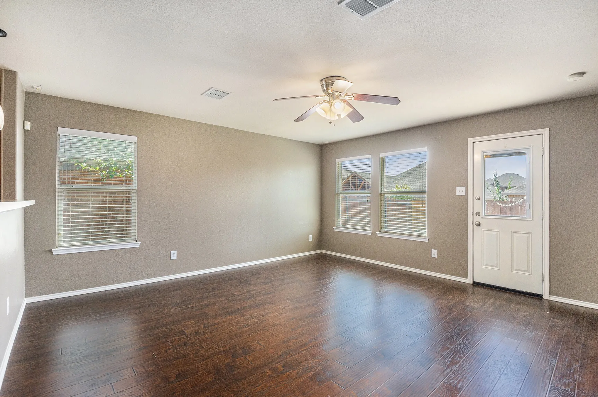 Foyer entrance featuring dark wood-style flooring and ceiling fan