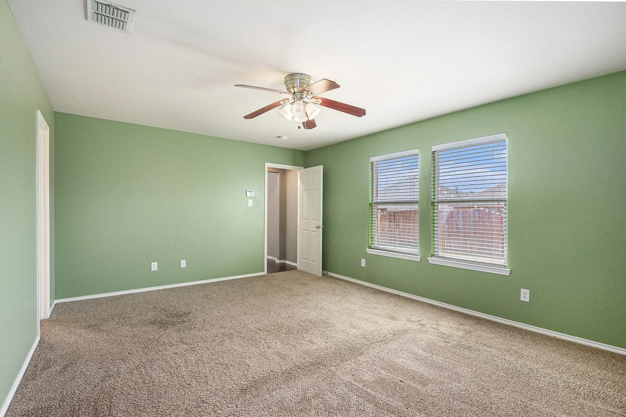 Unfurnished bedroom featuring carpet floors and a ceiling fan