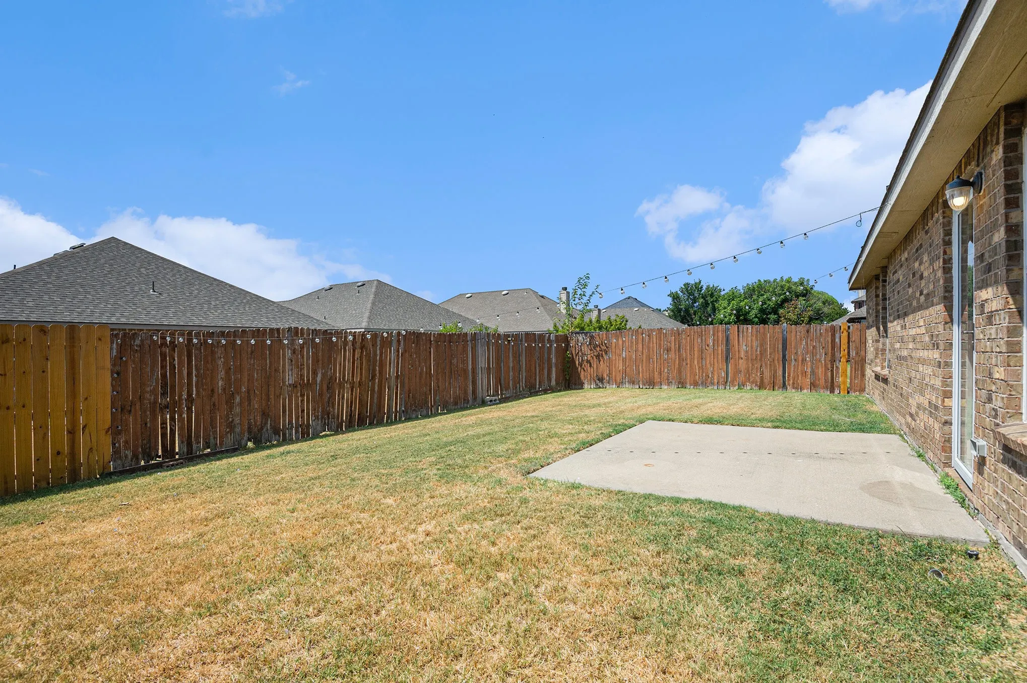Fenced backyard featuring a patio area