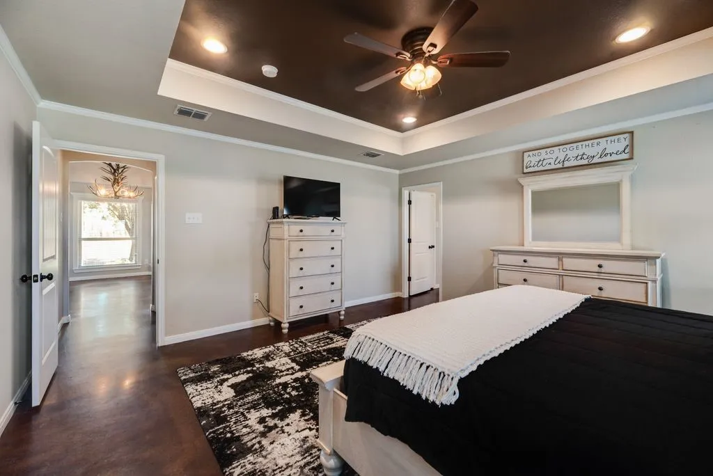 Coffer ceiling with recessed lighting and ceiling fan, wood-finish flooring, white trim, and a white interior door with black hardware