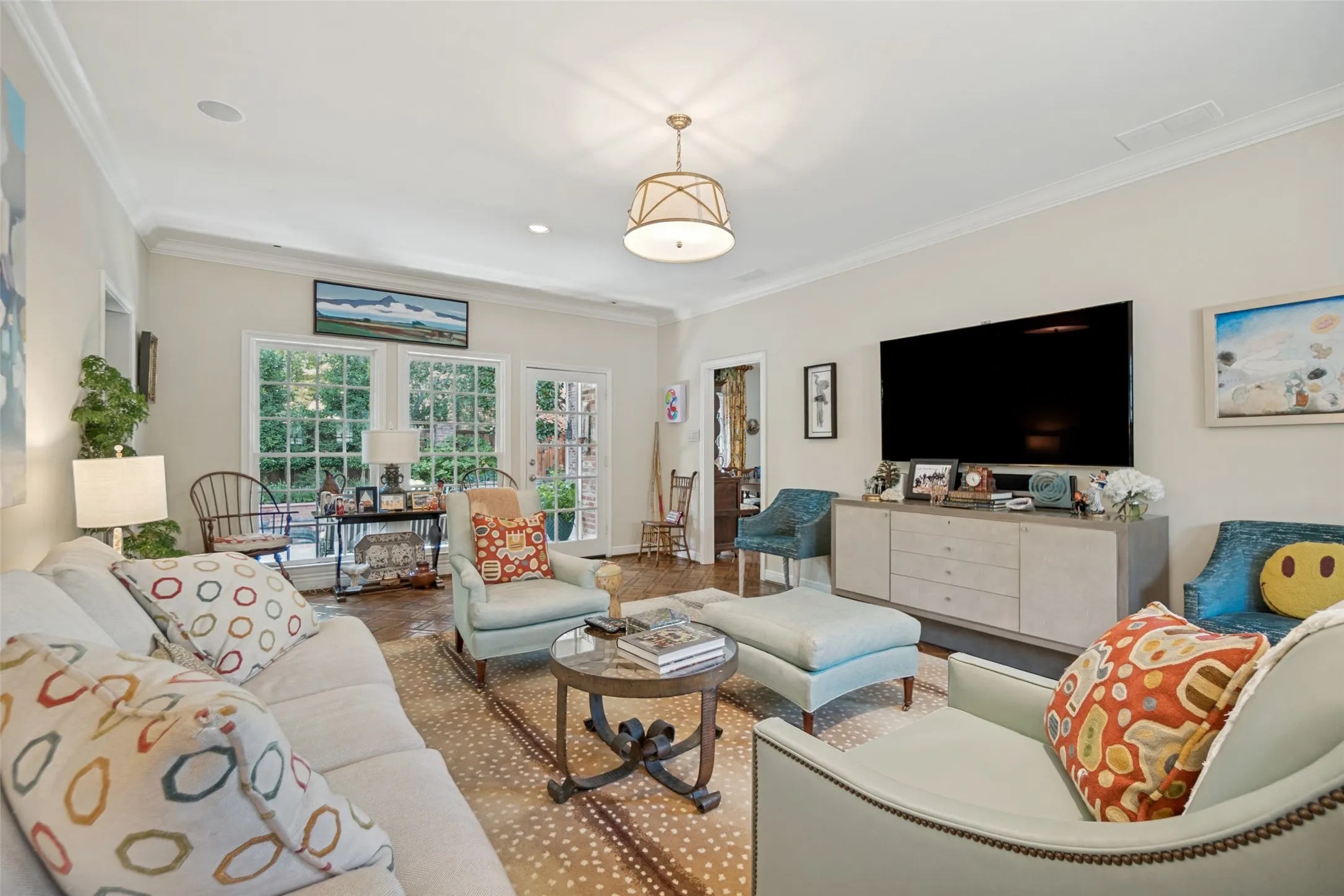 Recessed lighting, crown molding, wood-finish flooring, French doors, and an elegant drum pendant light