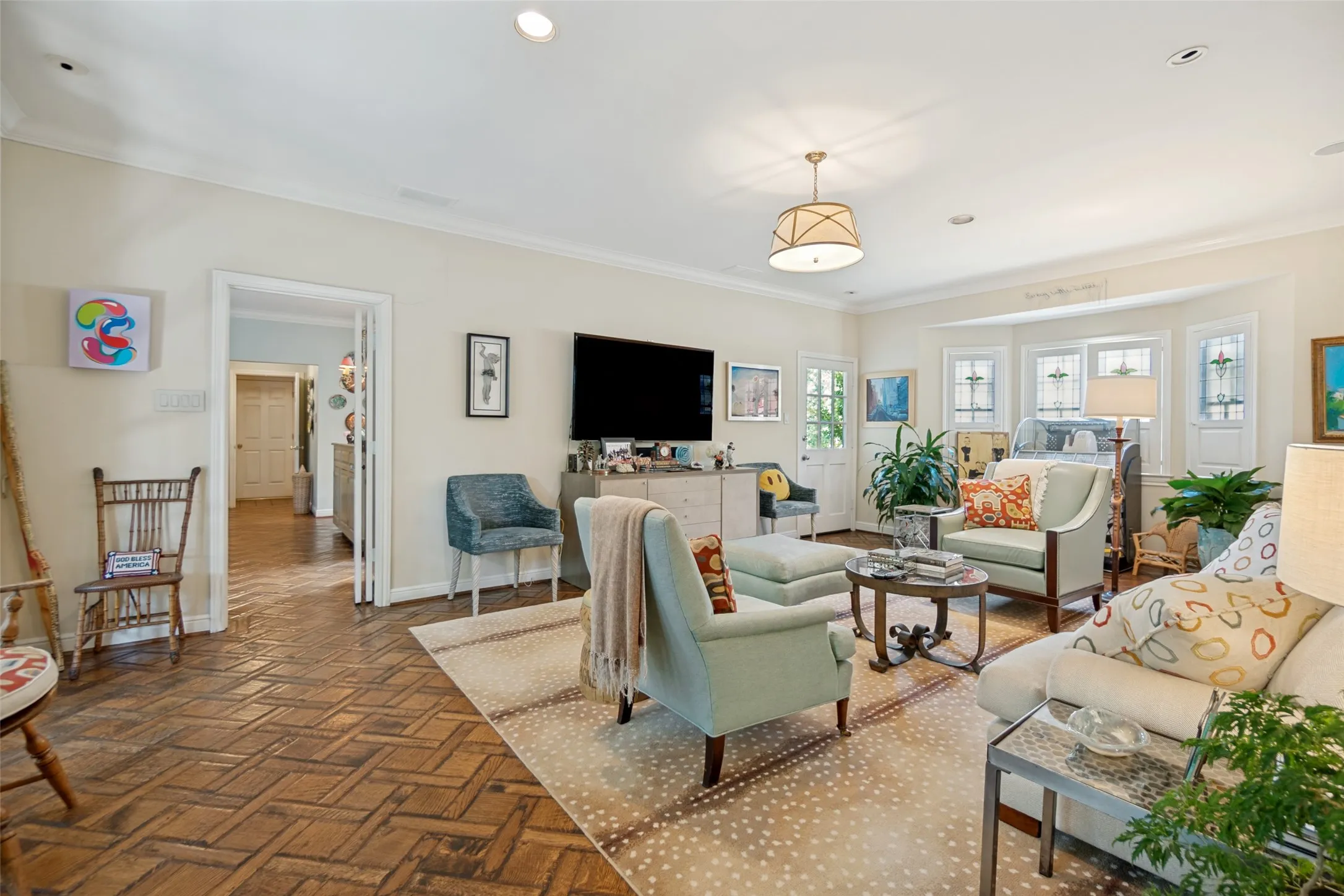 Recessed lighting, wood-finish flooring with a herringbone pattern, bay windows, crown molding, and a drum-style ceiling fixture