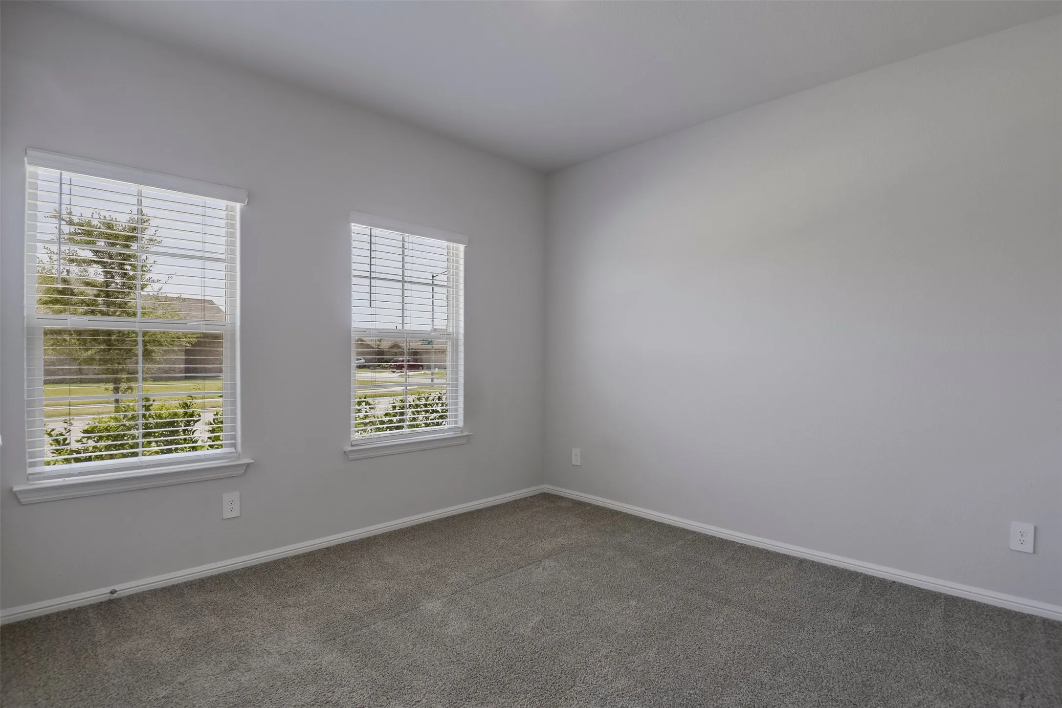 Gray textured carpet and light gray wall paint with white trim