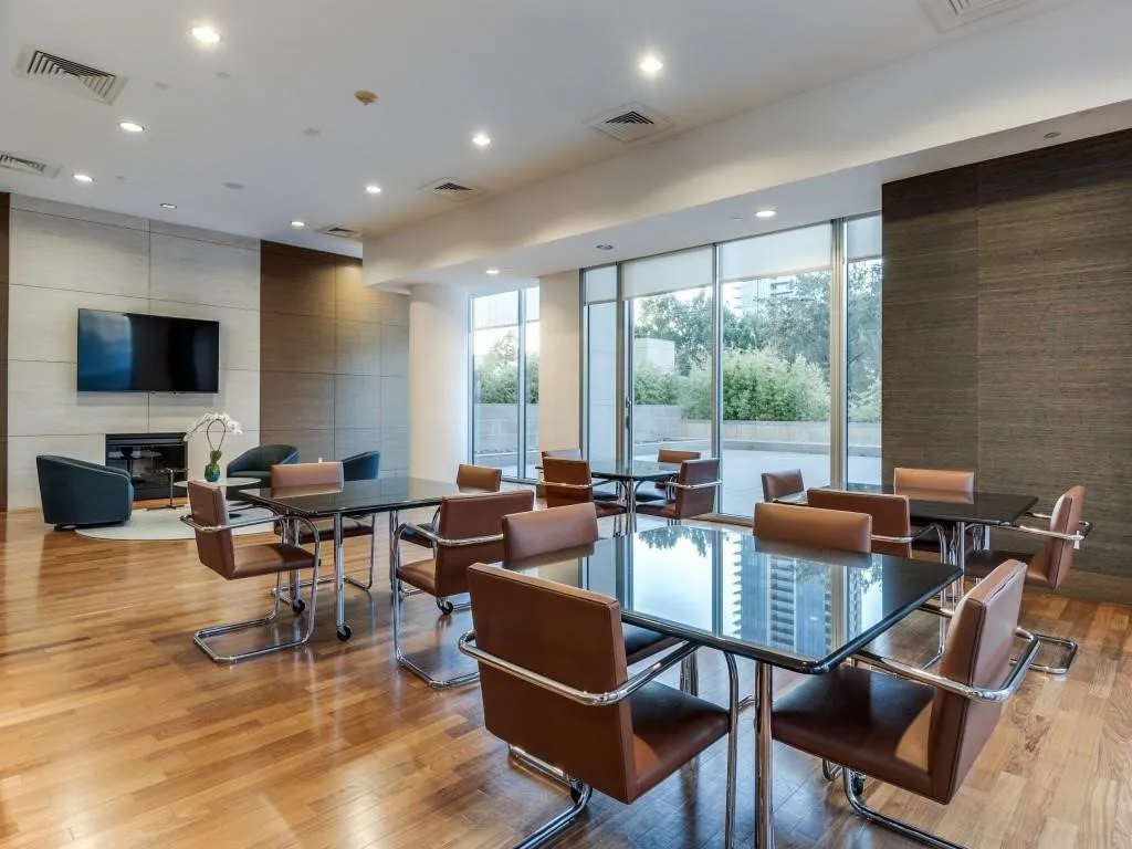 Spacious common area featuring wood-finish flooring, recessed lighting, and expansive windows