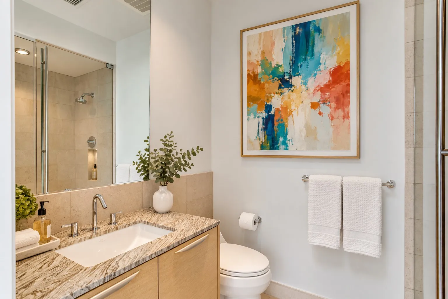Bathroom featuring a vanity with a stone countertop, an undermount sink with a chrome faucet, and wood-finish cabinetry