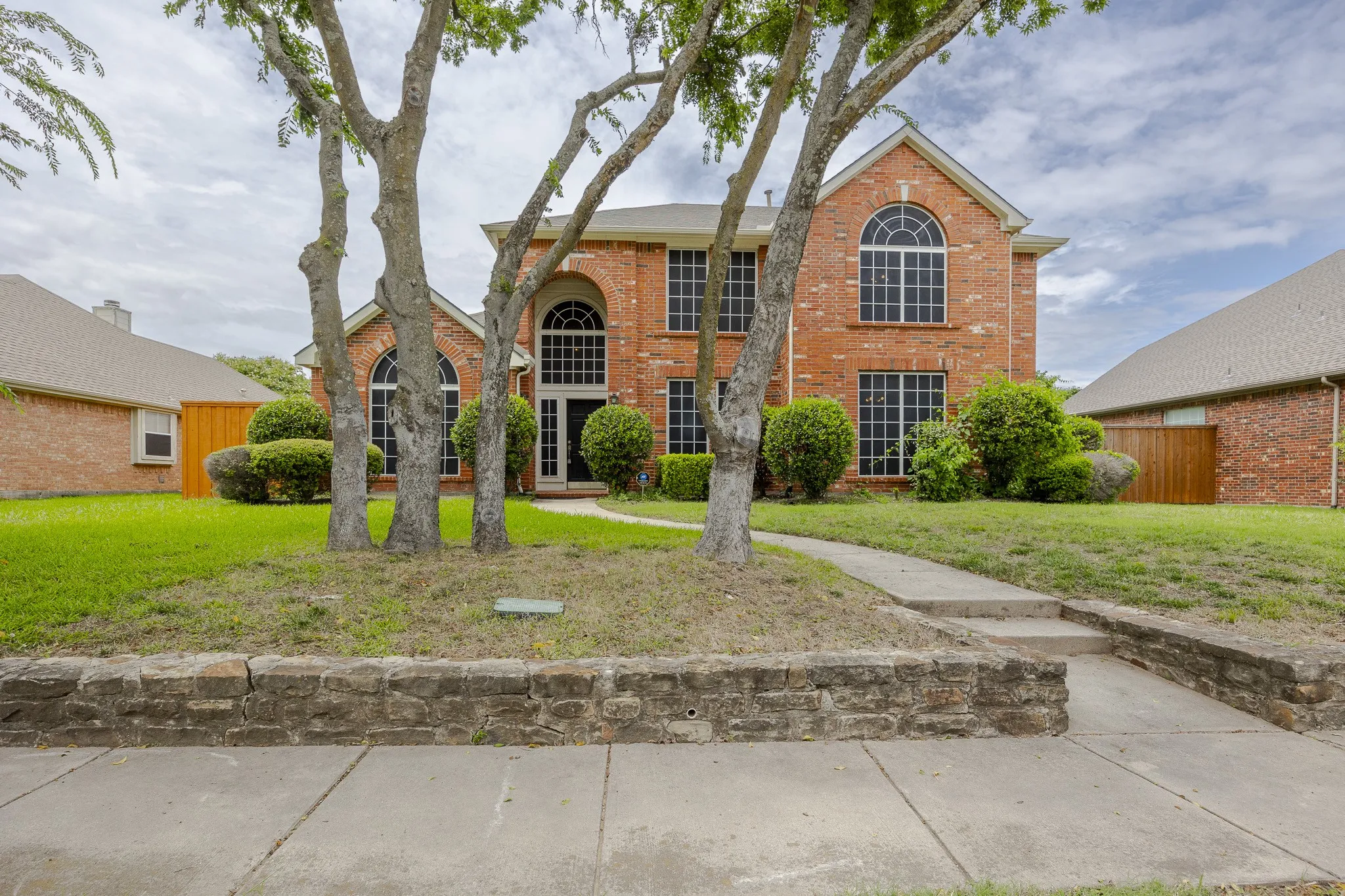 Traditional home featuring brick siding