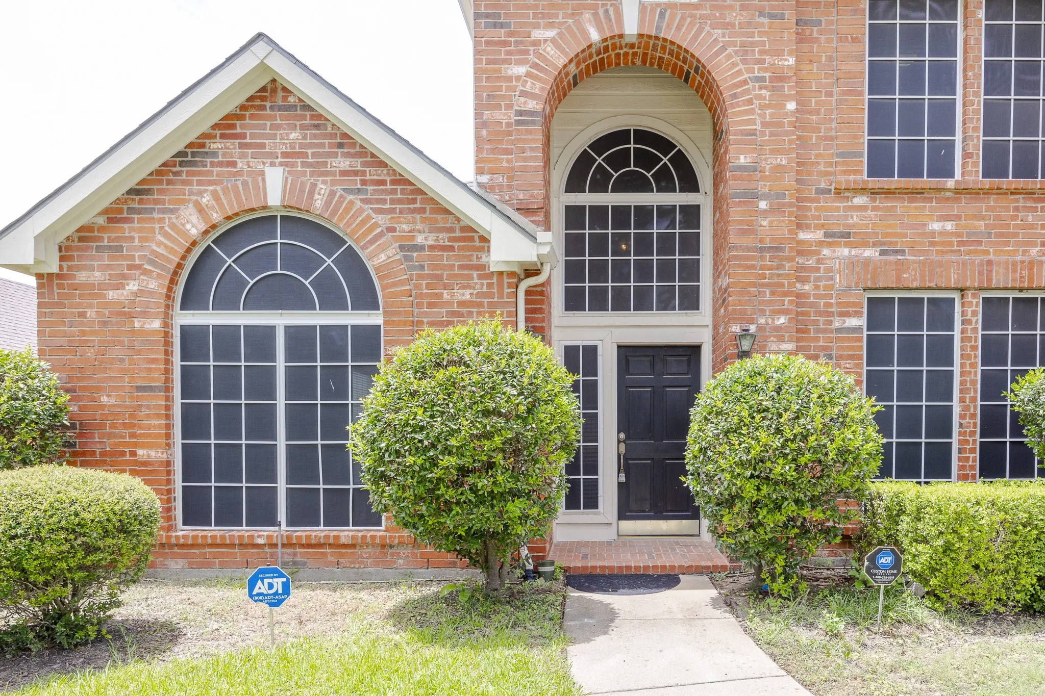 Doorway to property featuring brick siding