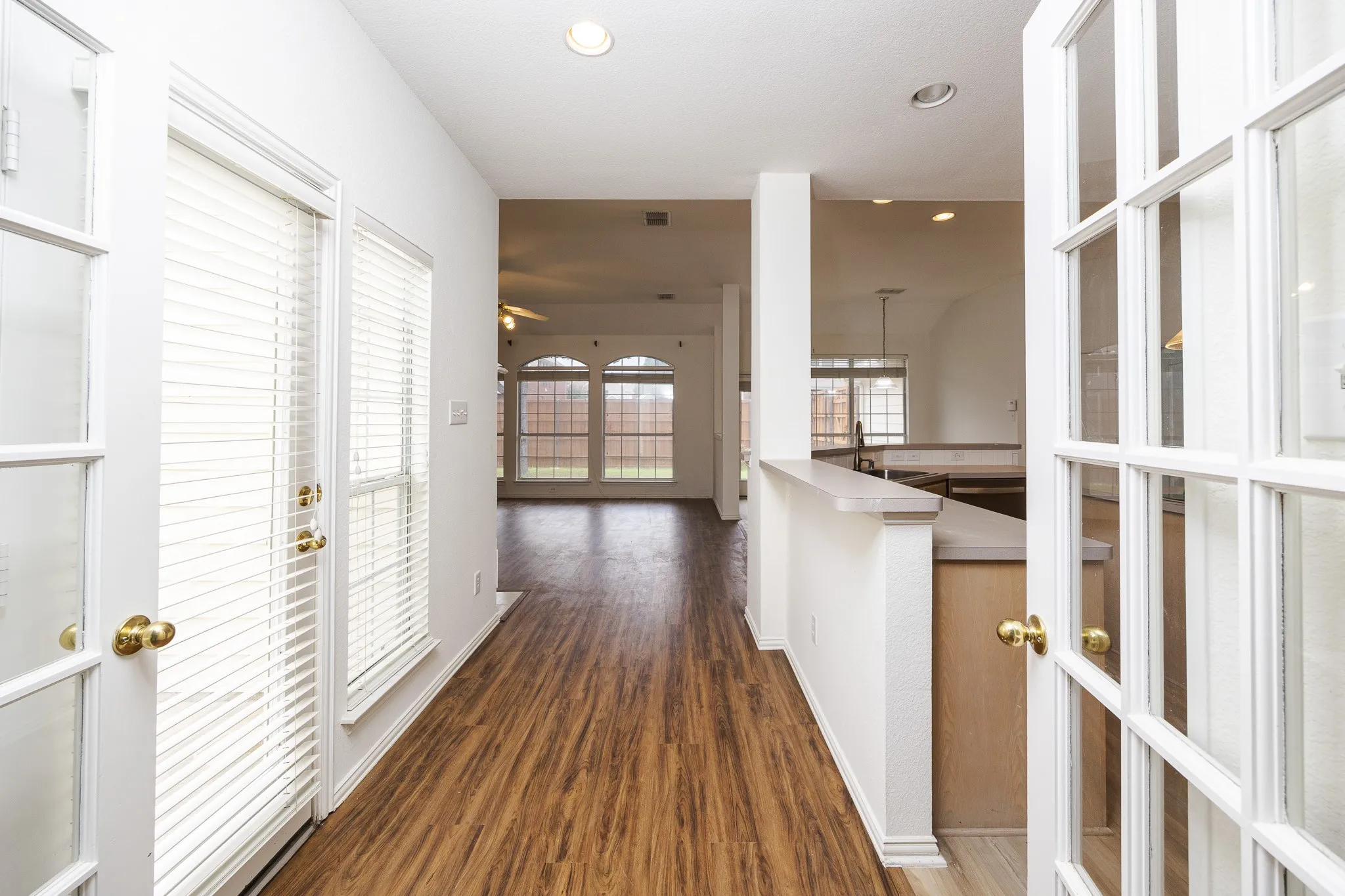 Corridor featuring dark wood-style flooring and recessed lighting