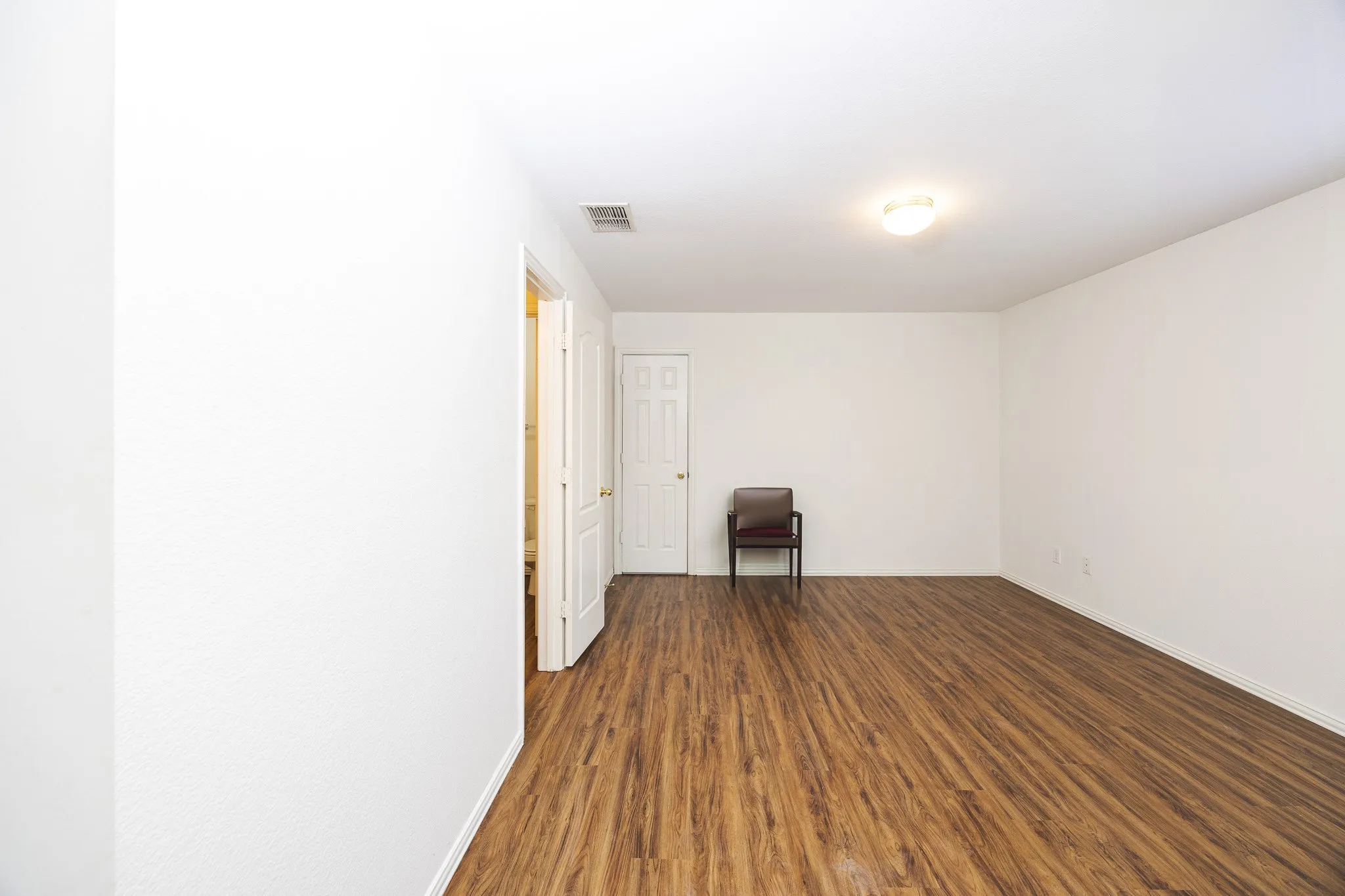 Spare room with dark wood-type flooring