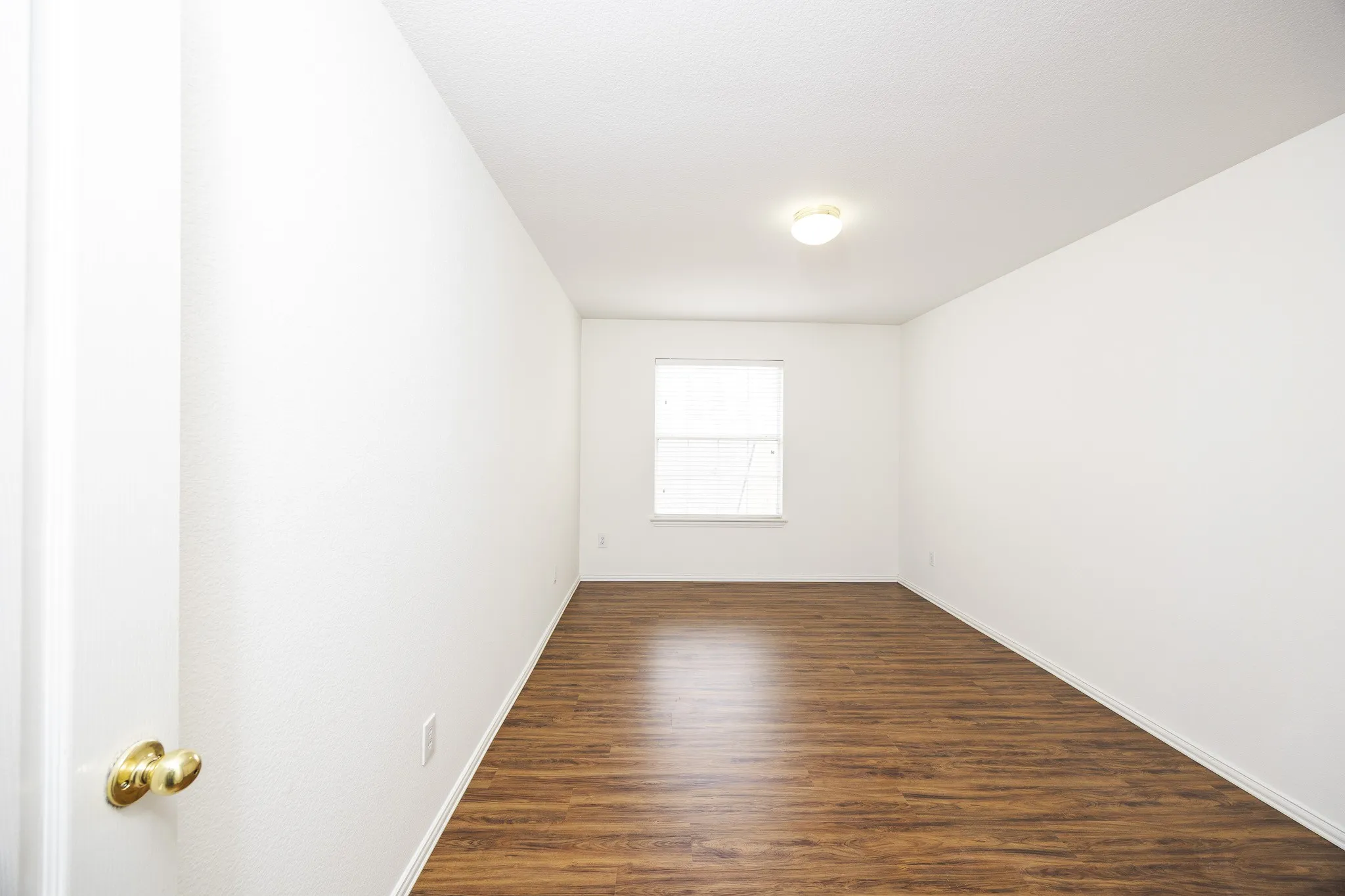 Unfurnished room with dark wood-type flooring and baseboards